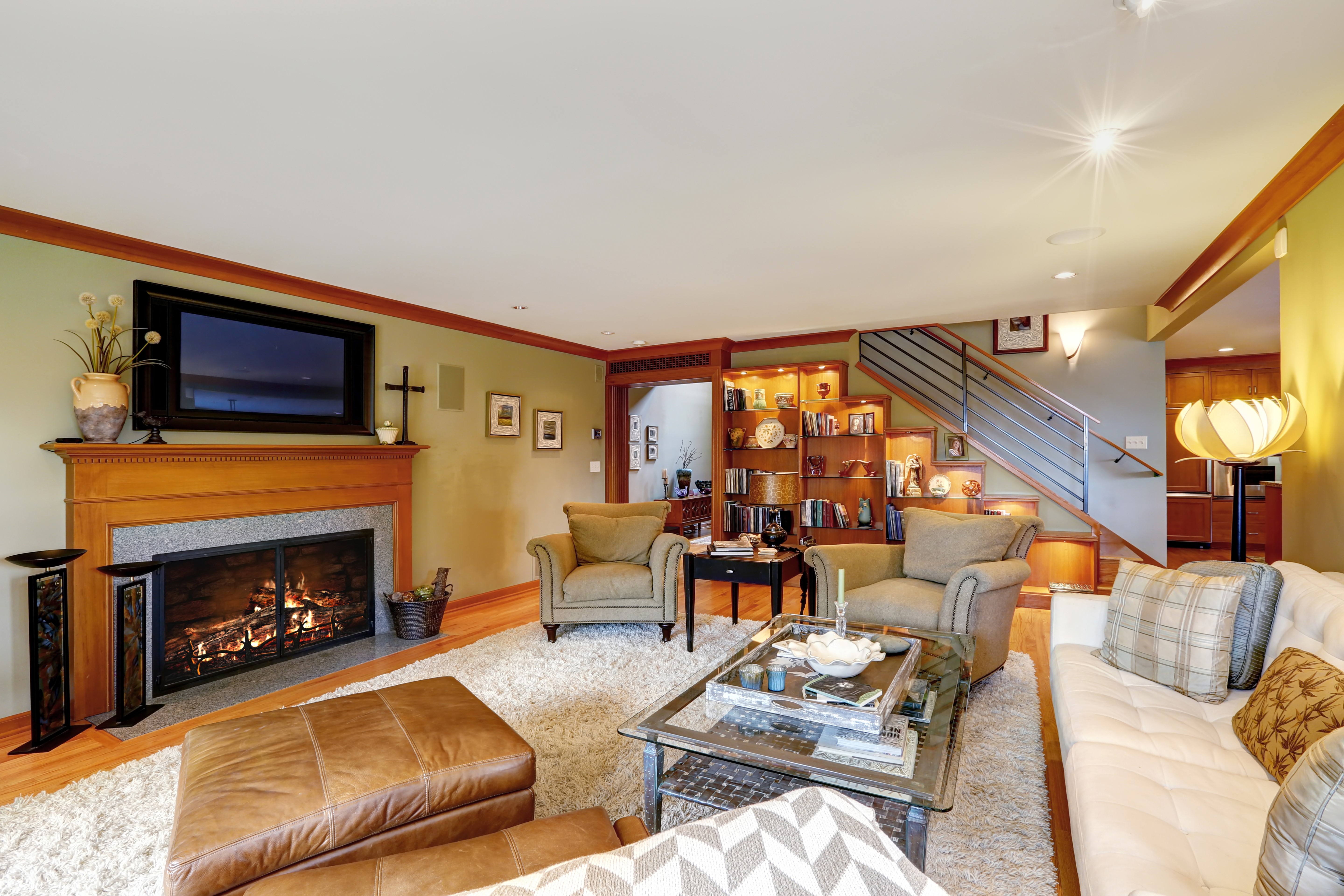 Living room with fireplace, sofa, and armchairs HD Wallpaper