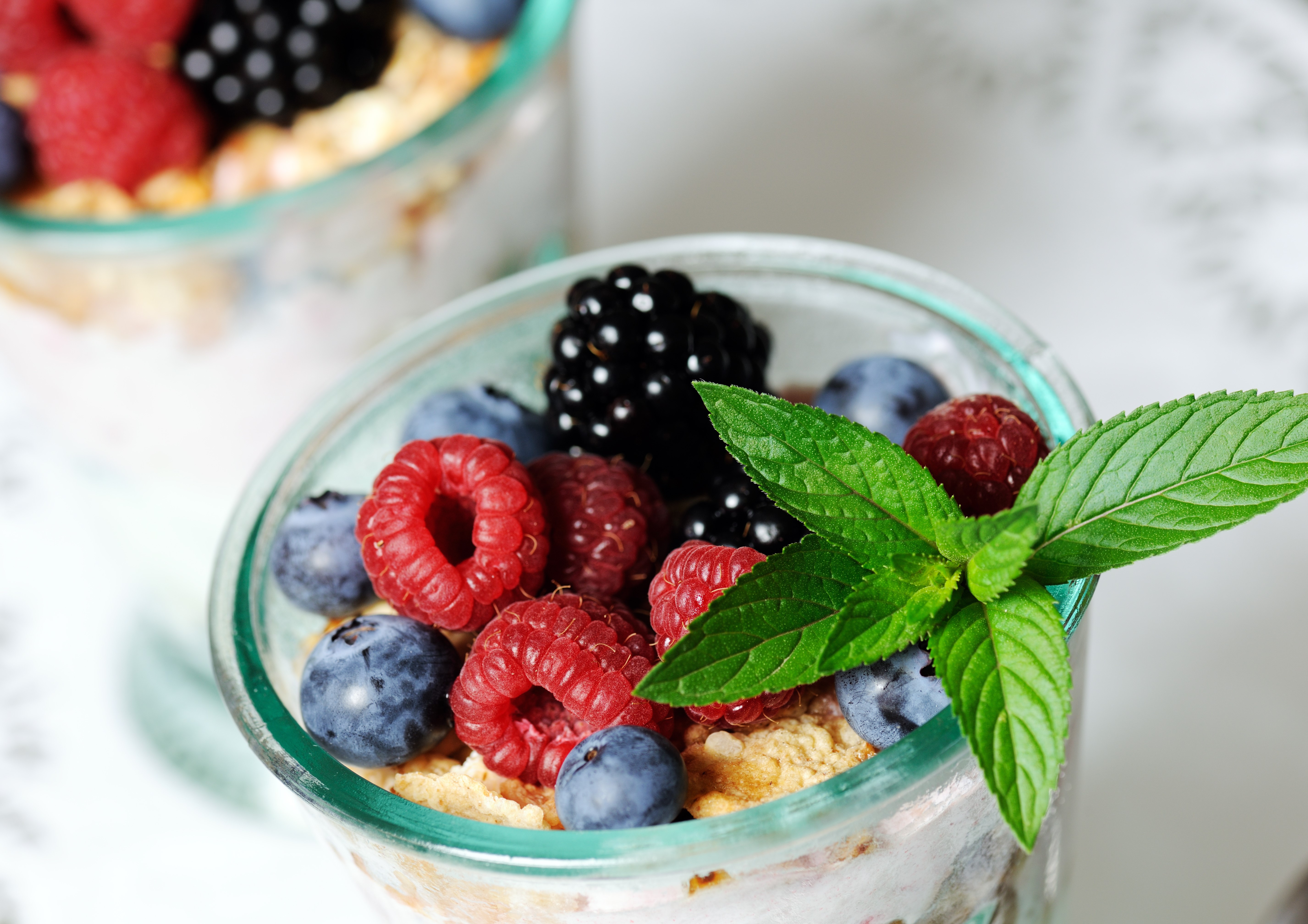 Close-up of a glass jar filled with berries and granola HD Wallpaper