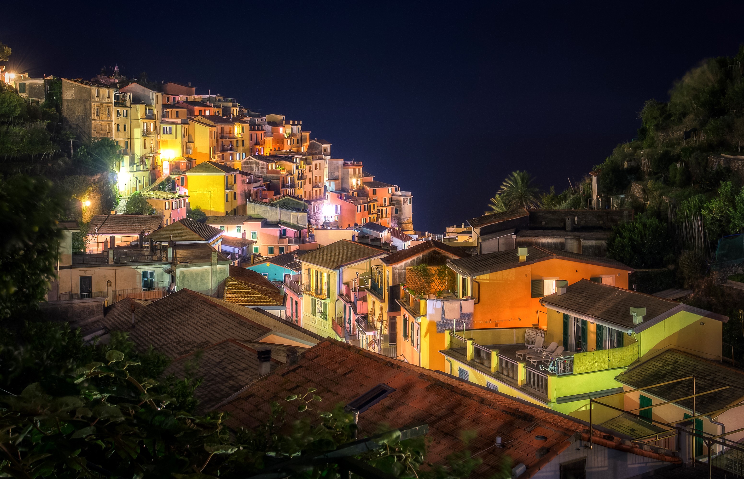 Manarola, Italy at night with colorful houses on a hill HD Wallpaper