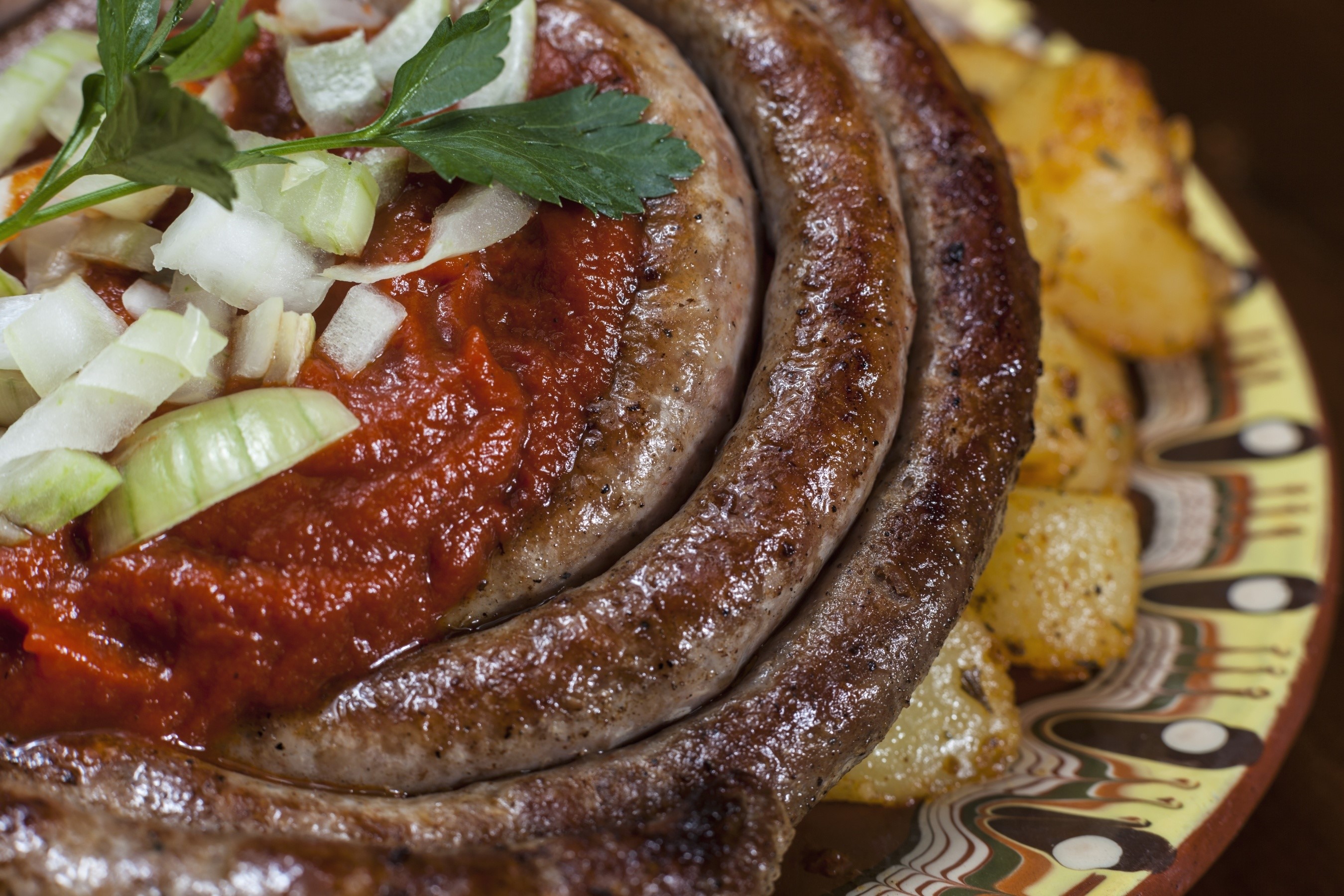Sausage with sauce and potatoes on a plate HD Wallpaper