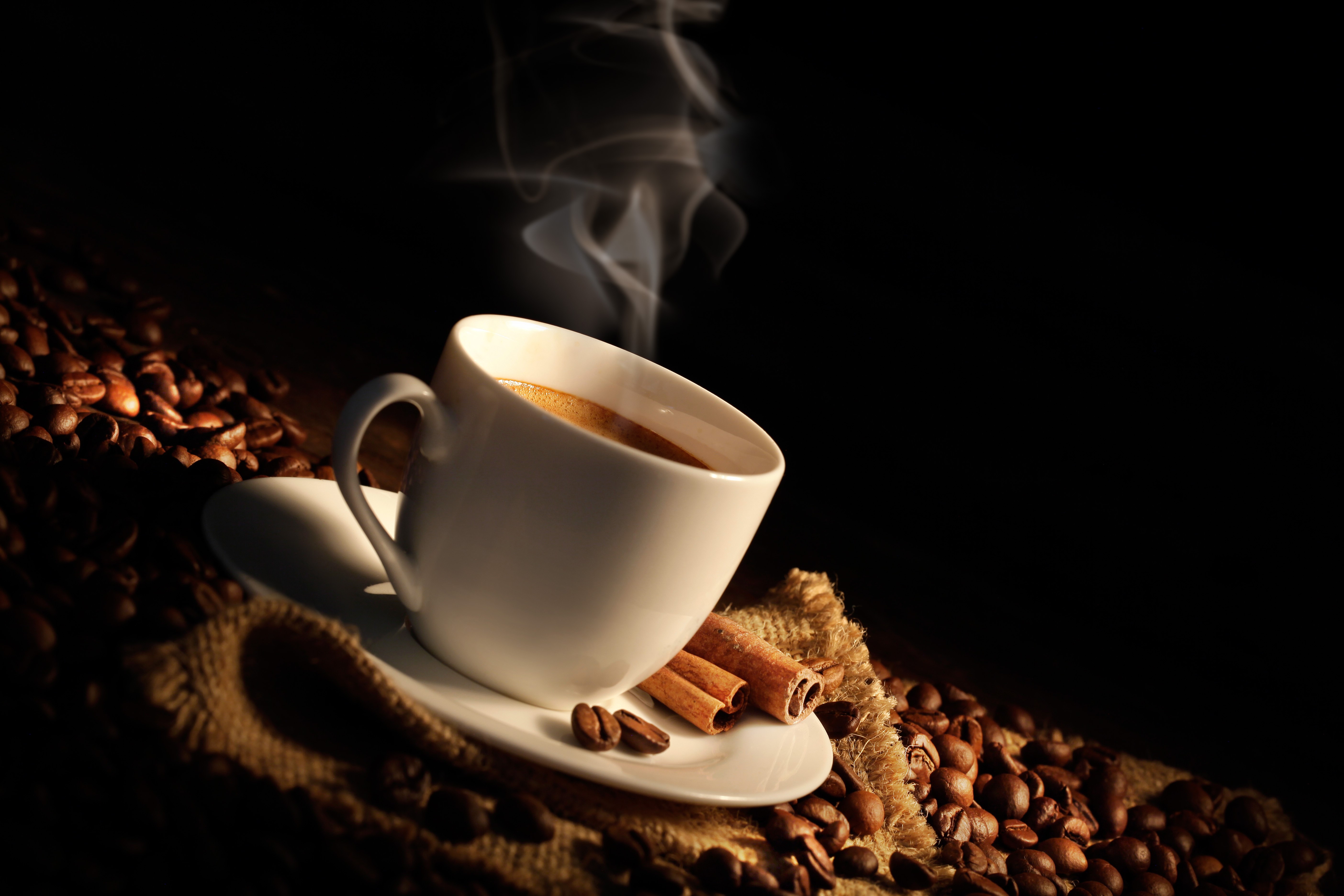 Coffee cup with steam and cinnamon sticks HD Wallpaper