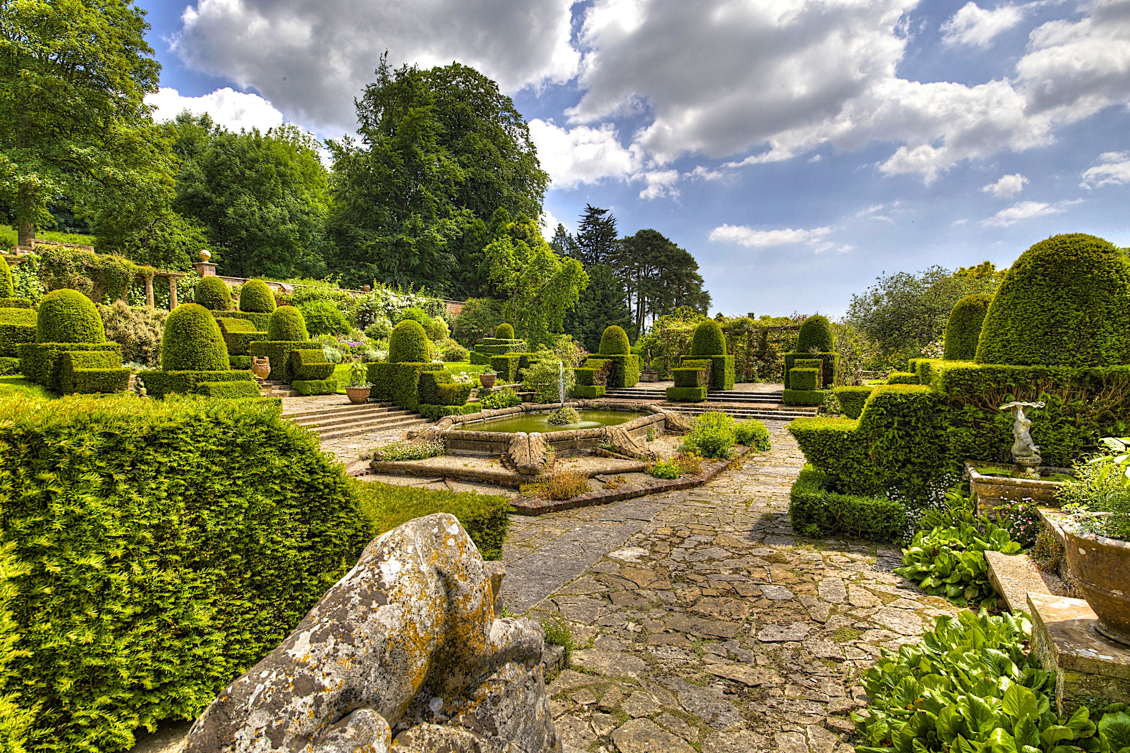 Topiary garden with fountain and stone path in Mapperton, England HD Wallpaper