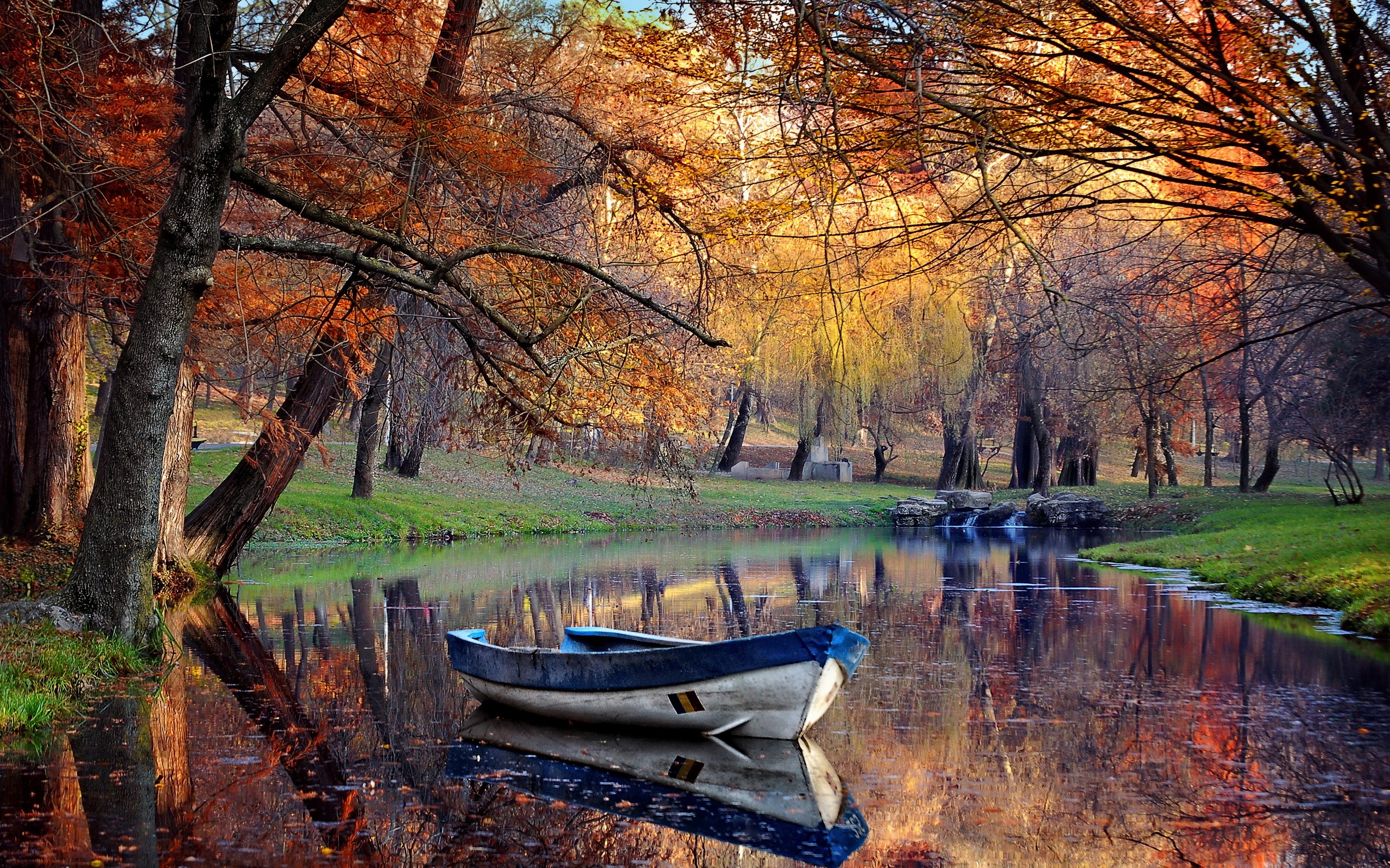 Boat on a calm lake in an autumn park HD Wallpaper