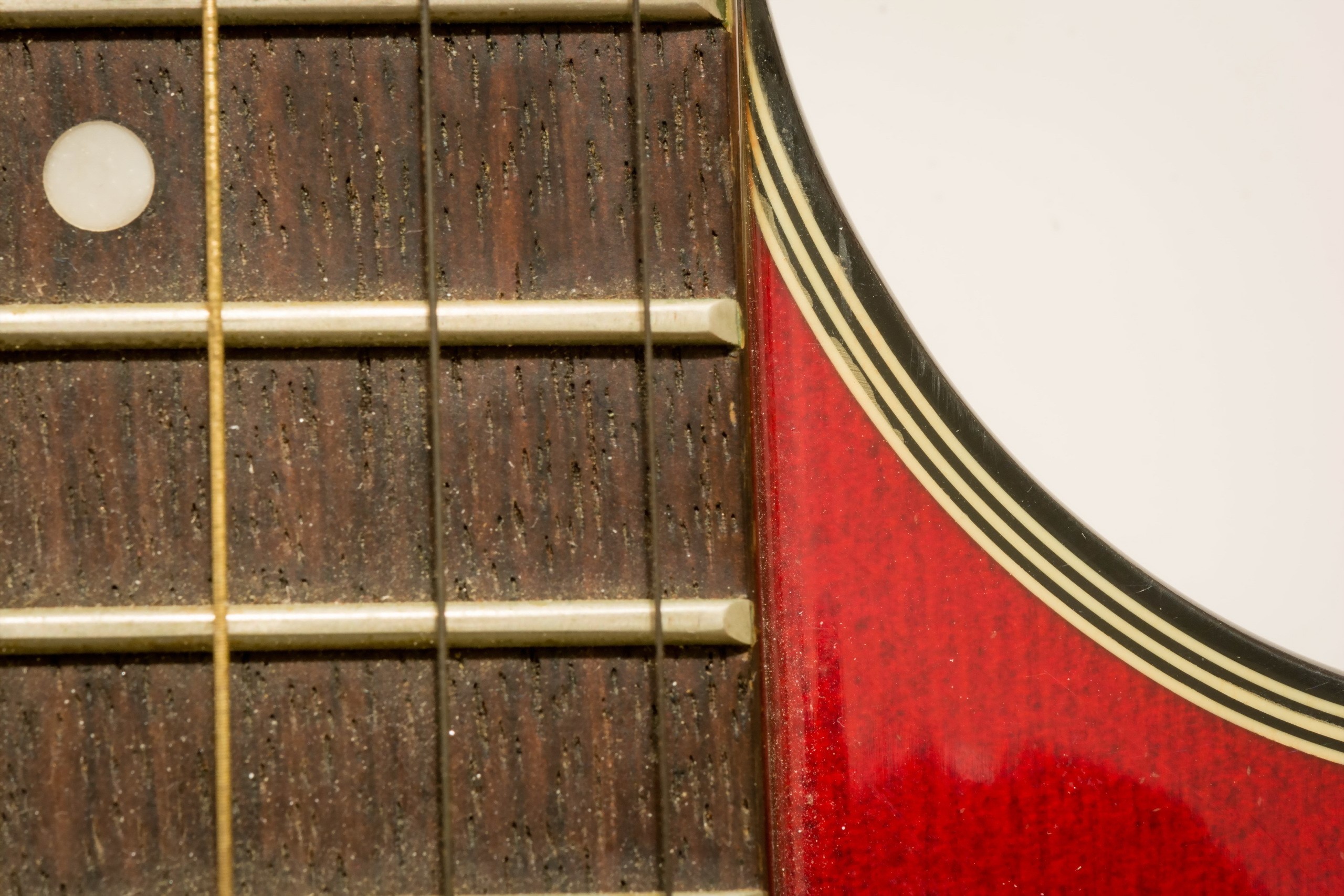 Close-up of a guitar fretboard and body HD Wallpaper