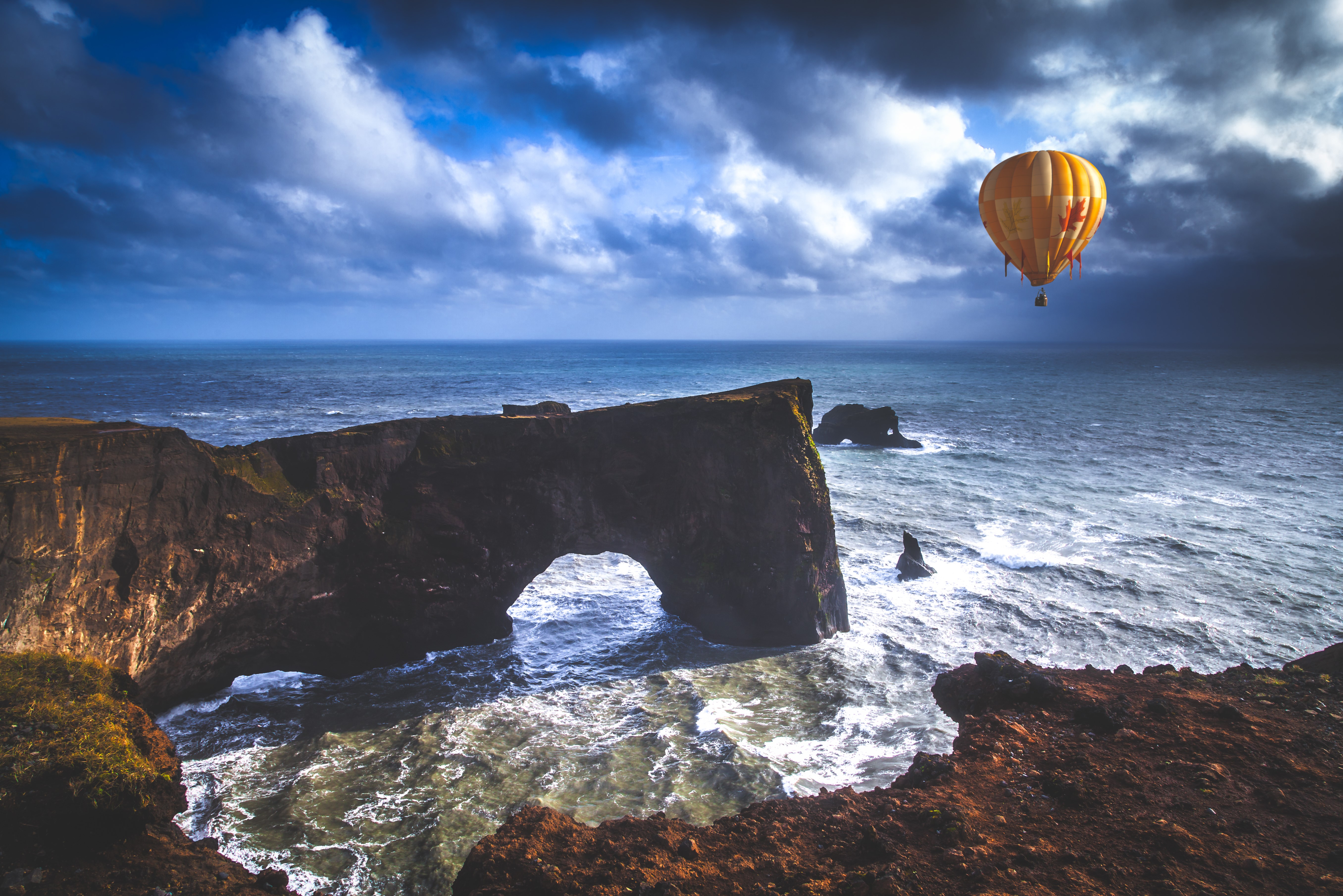 Hot air balloon over sea arch cliff HD Wallpaper