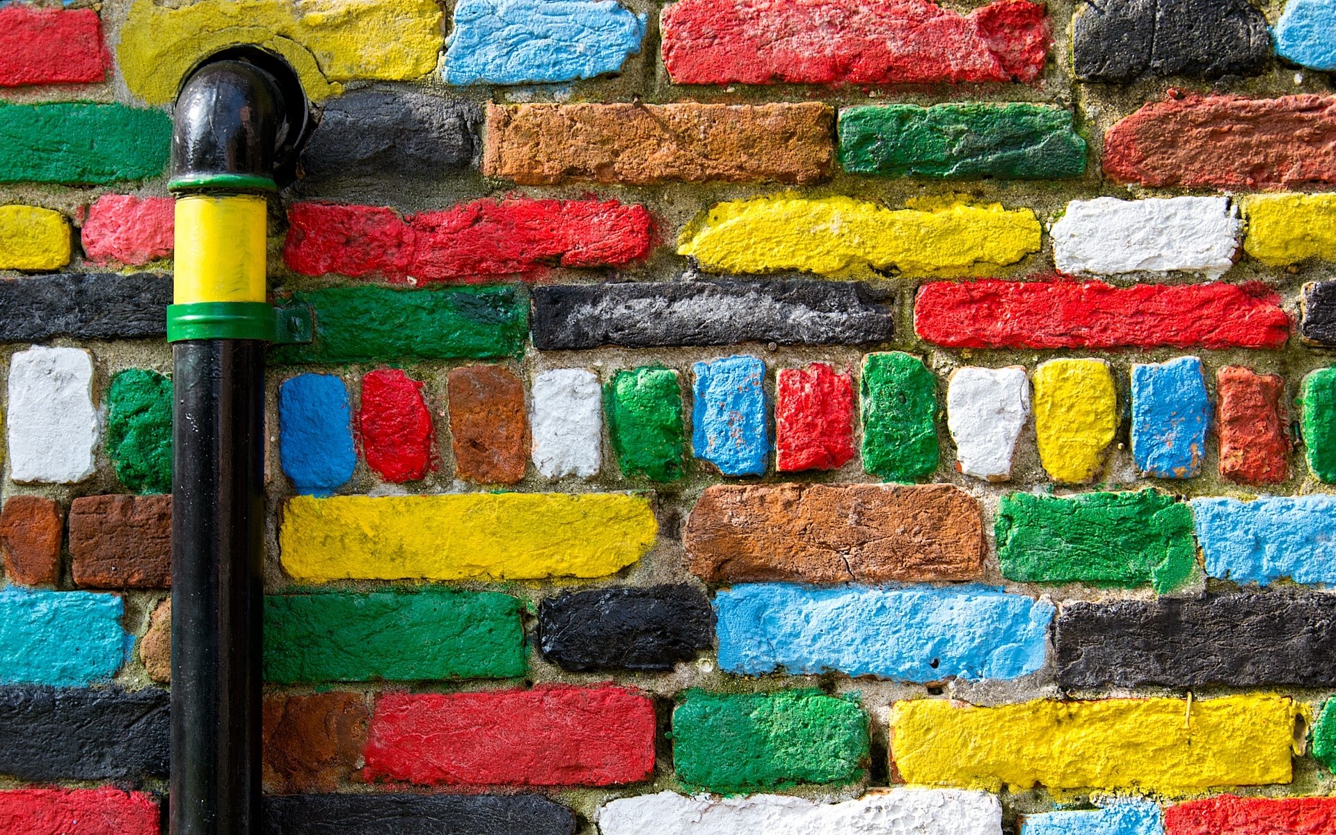 Colorful brick wall with a pipe HD Wallpaper