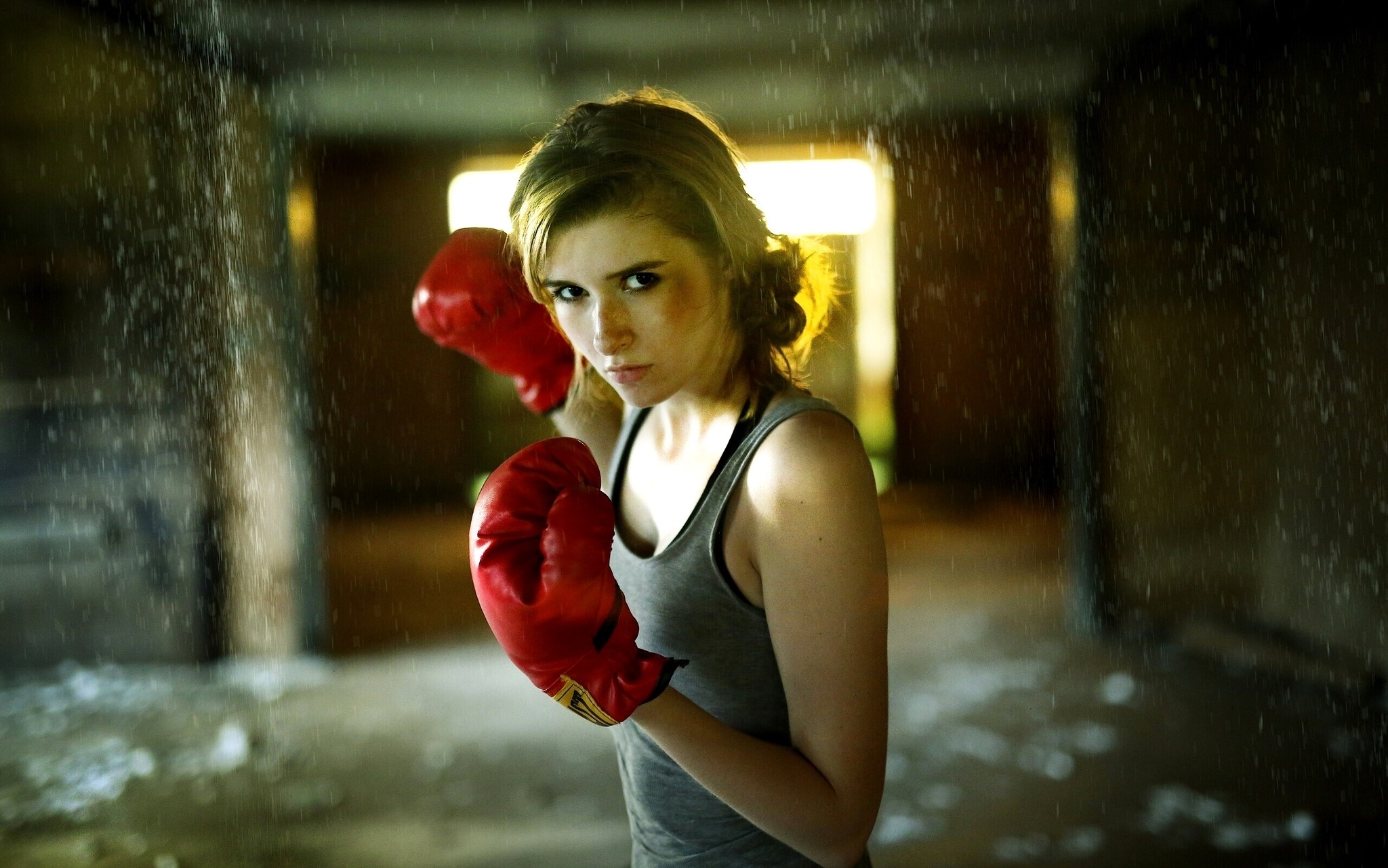Woman in boxing gloves in a dark hallway HD Wallpaper