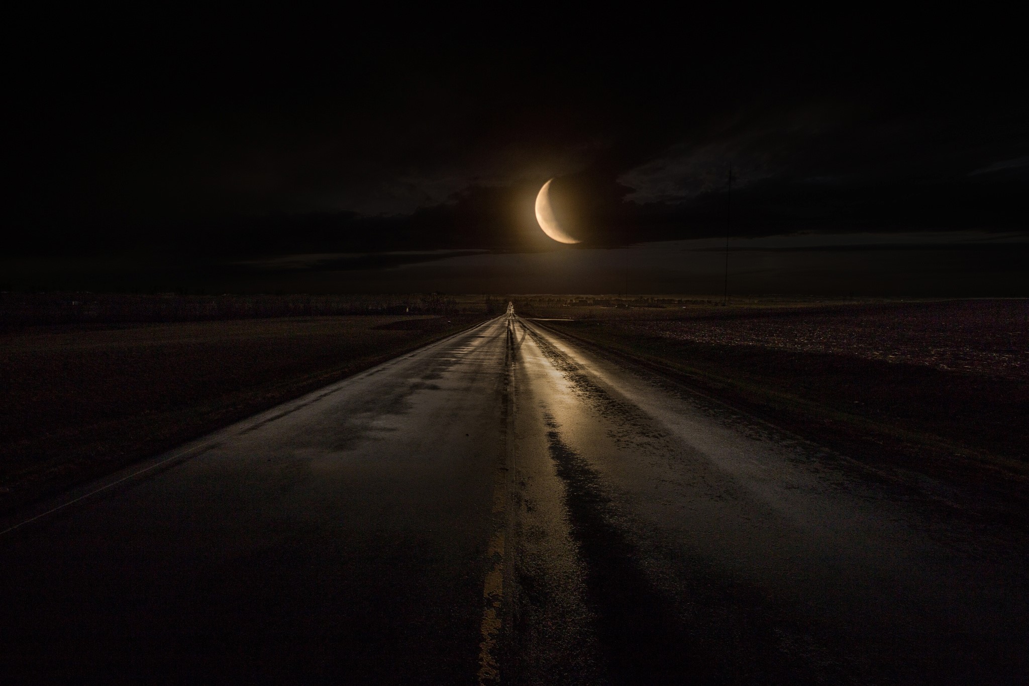 Road at night under a crescent moon HD Wallpaper