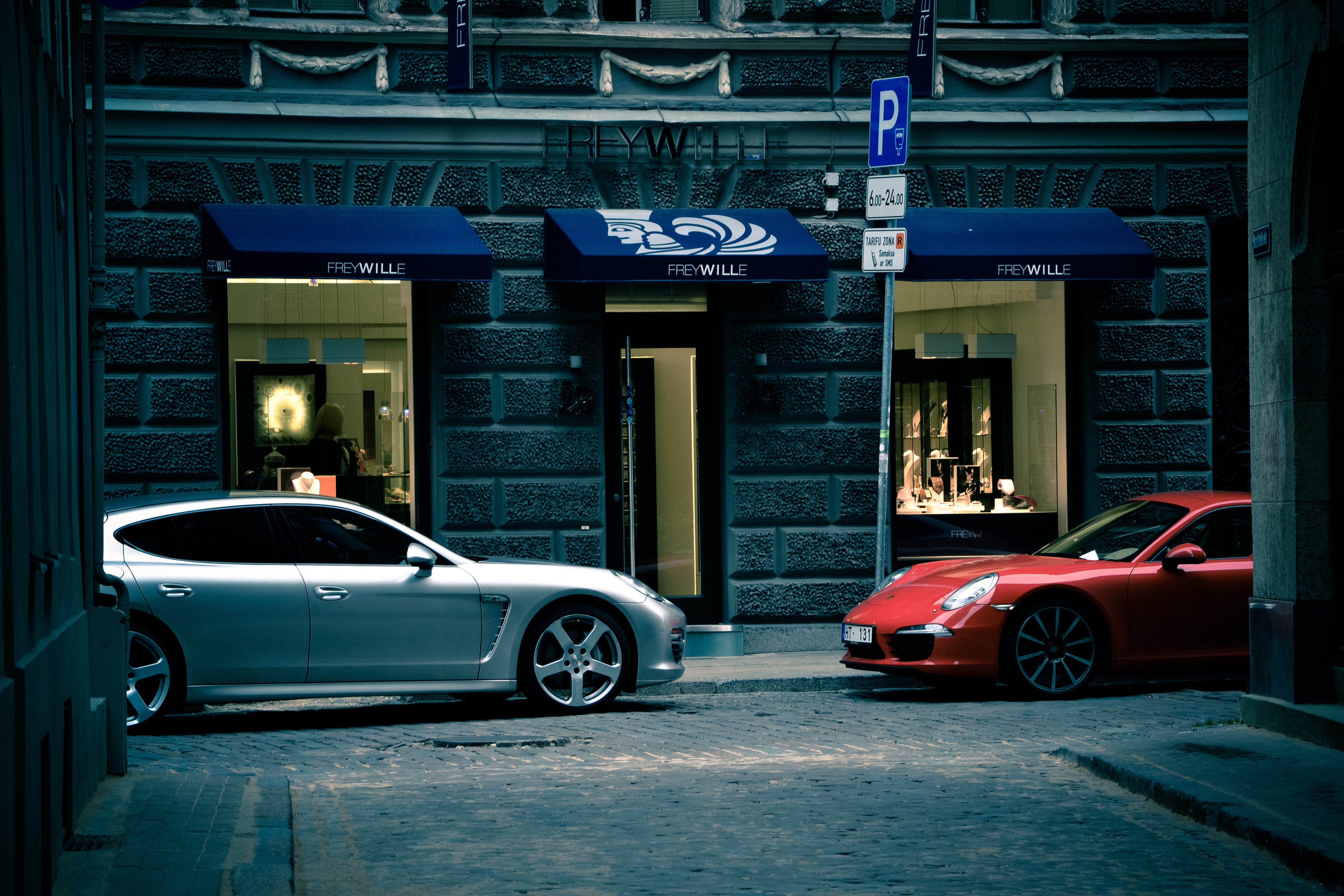 Two Porsche cars parked outside Frey Wille store HD Wallpaper