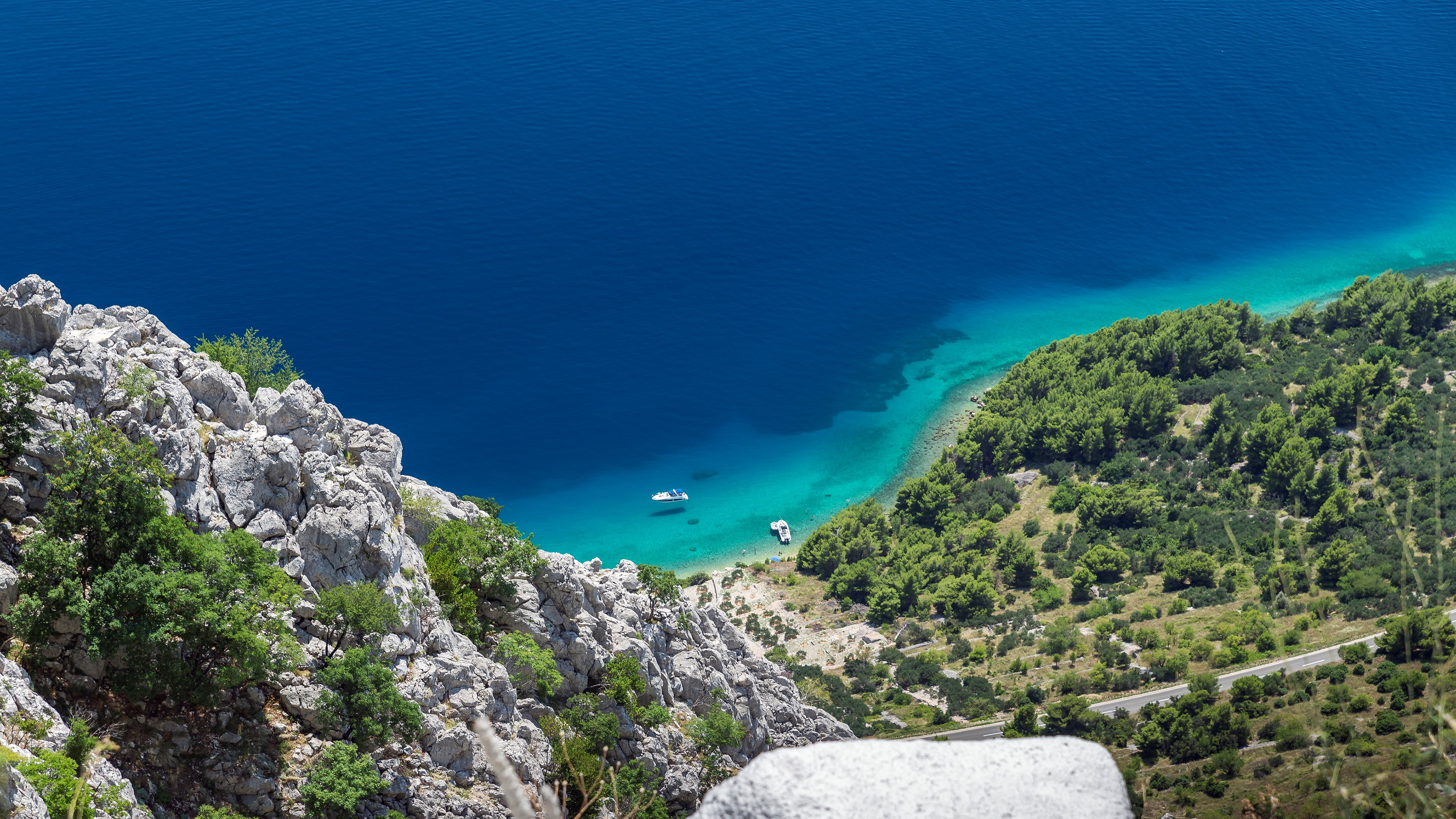 View from mountain overlooking turquoise sea and rocky coast HD Wallpaper