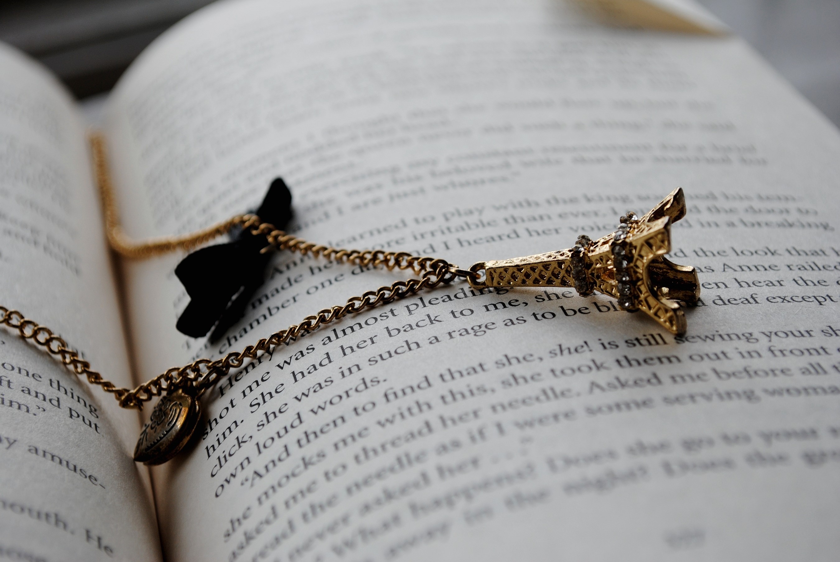 Eiffel Tower Necklace on Open Book HD Wallpaper