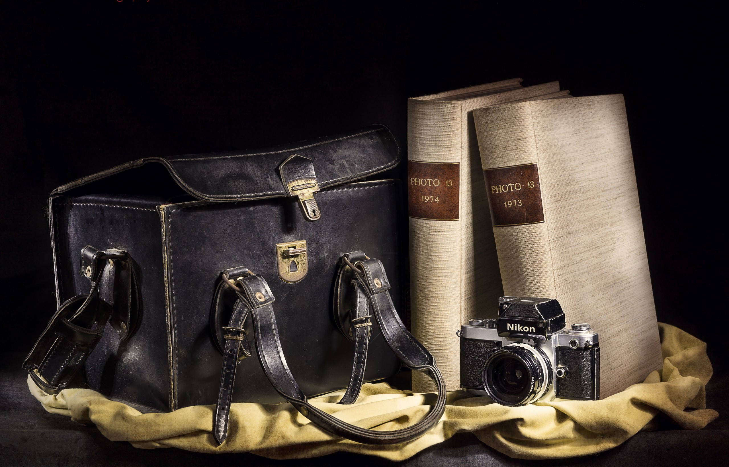 Nikon camera, leather bag, and photo albums HD Wallpaper