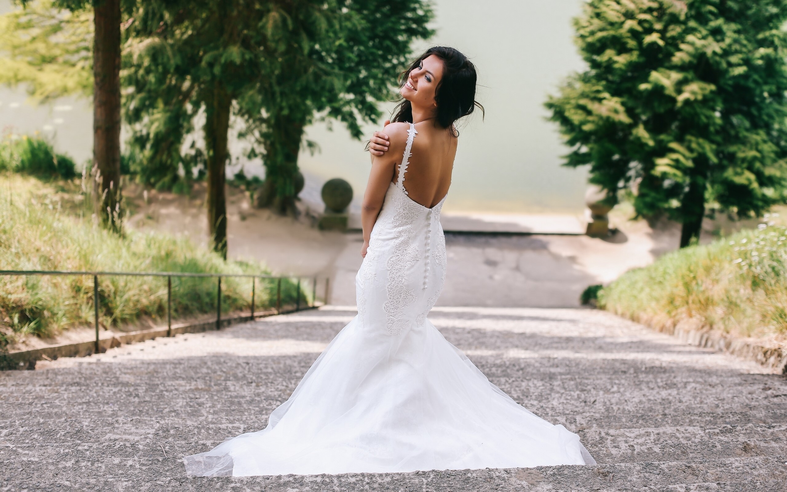 Bride in a white wedding dress on stairs HD Wallpaper