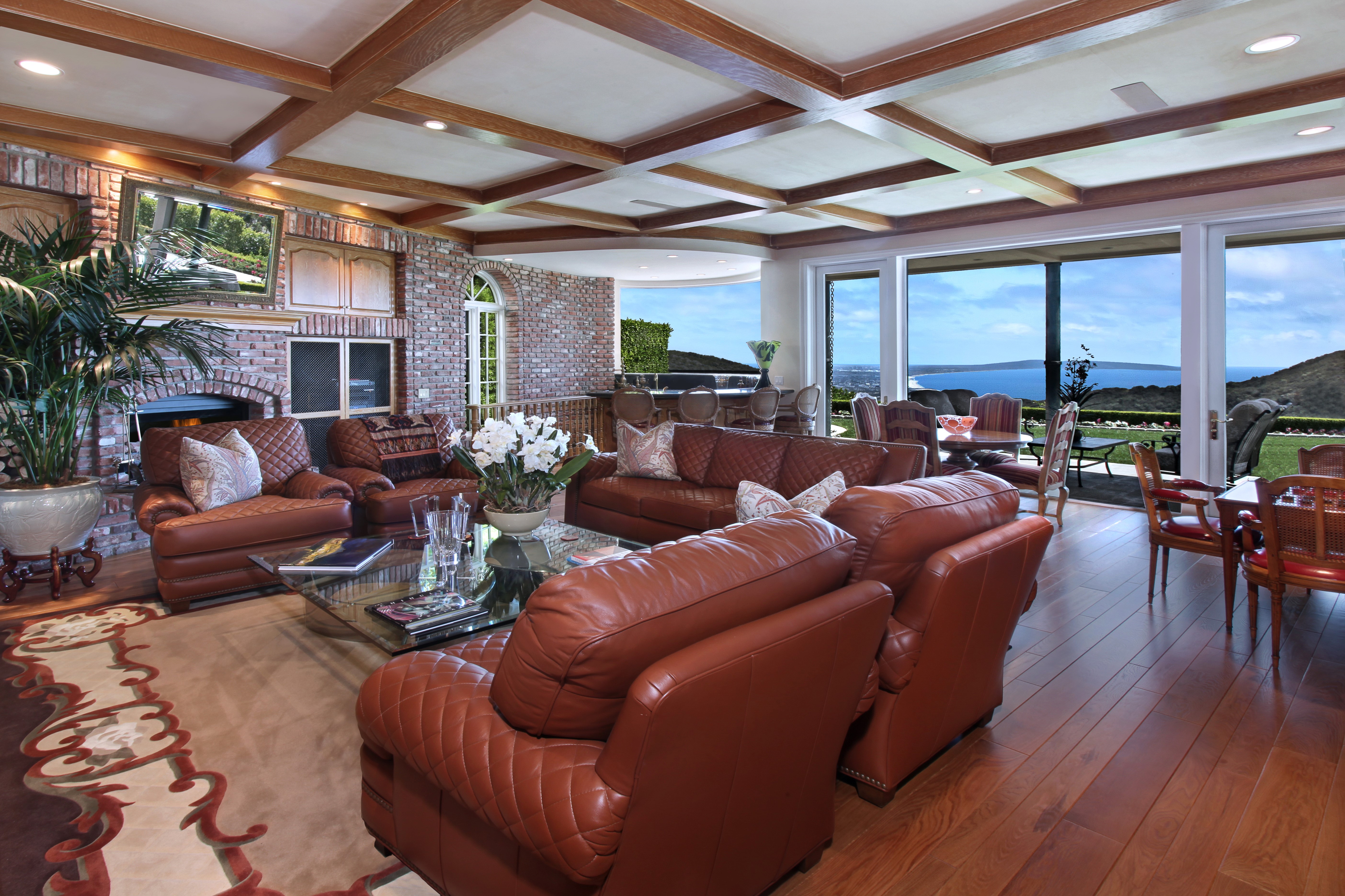 Living room with leather sofas and ocean view HD Wallpaper
