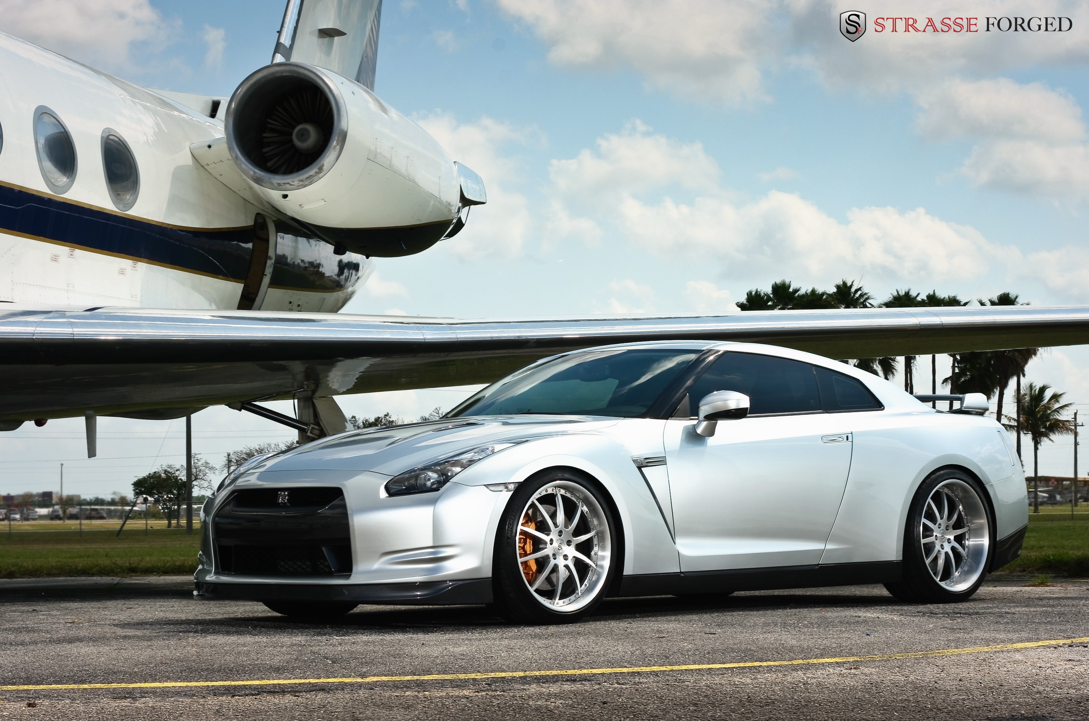 Silver Nissan GT-R with Strasse Forged Wheels next to Private Jet HD Wallpaper