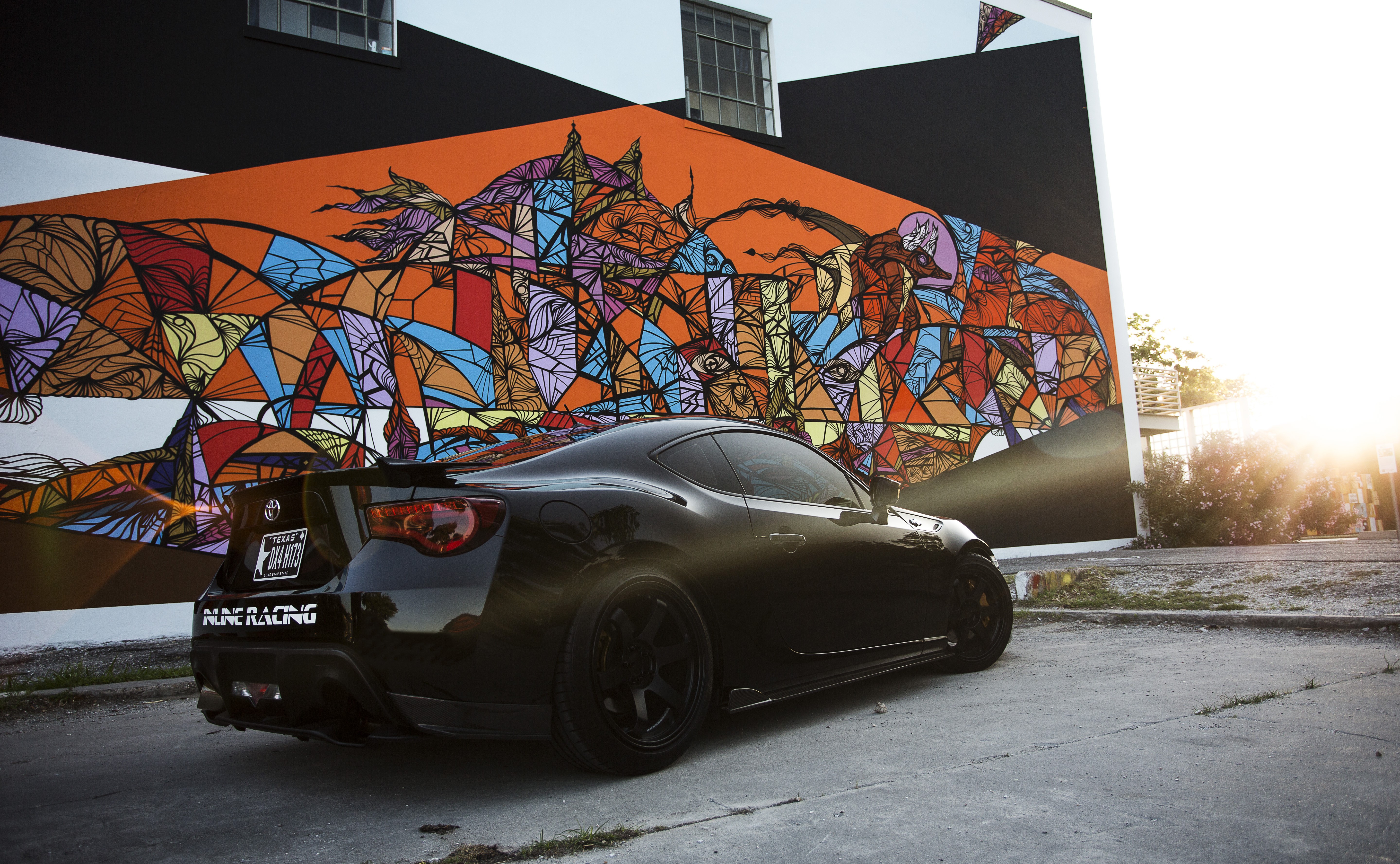 Black Toyota GT 86 parked in front of graffiti mural HD Wallpaper