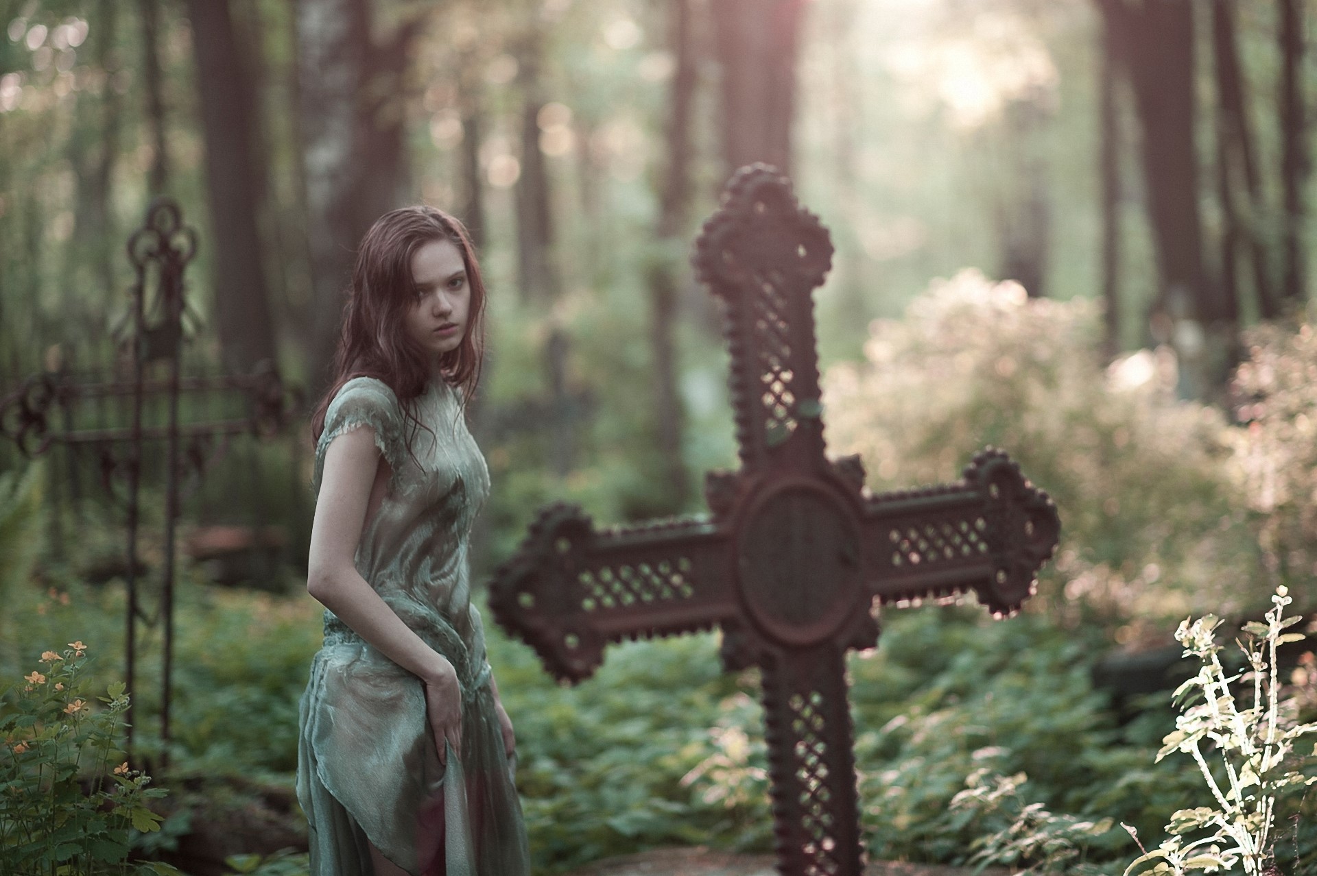 Young woman in a graveyard with crosses HD Wallpaper