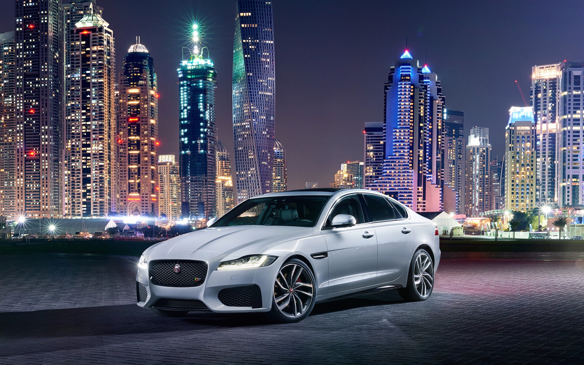 White Jaguar XF 2016 parked in Dubai at night HD Wallpaper