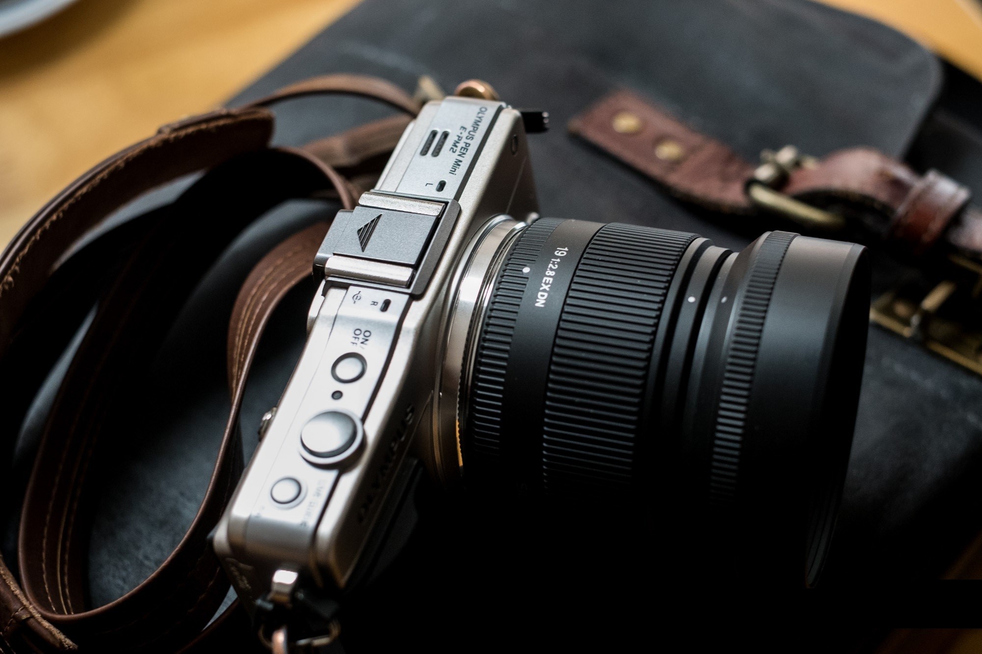 Olympus EPM2 camera with lens and strap HD Wallpaper