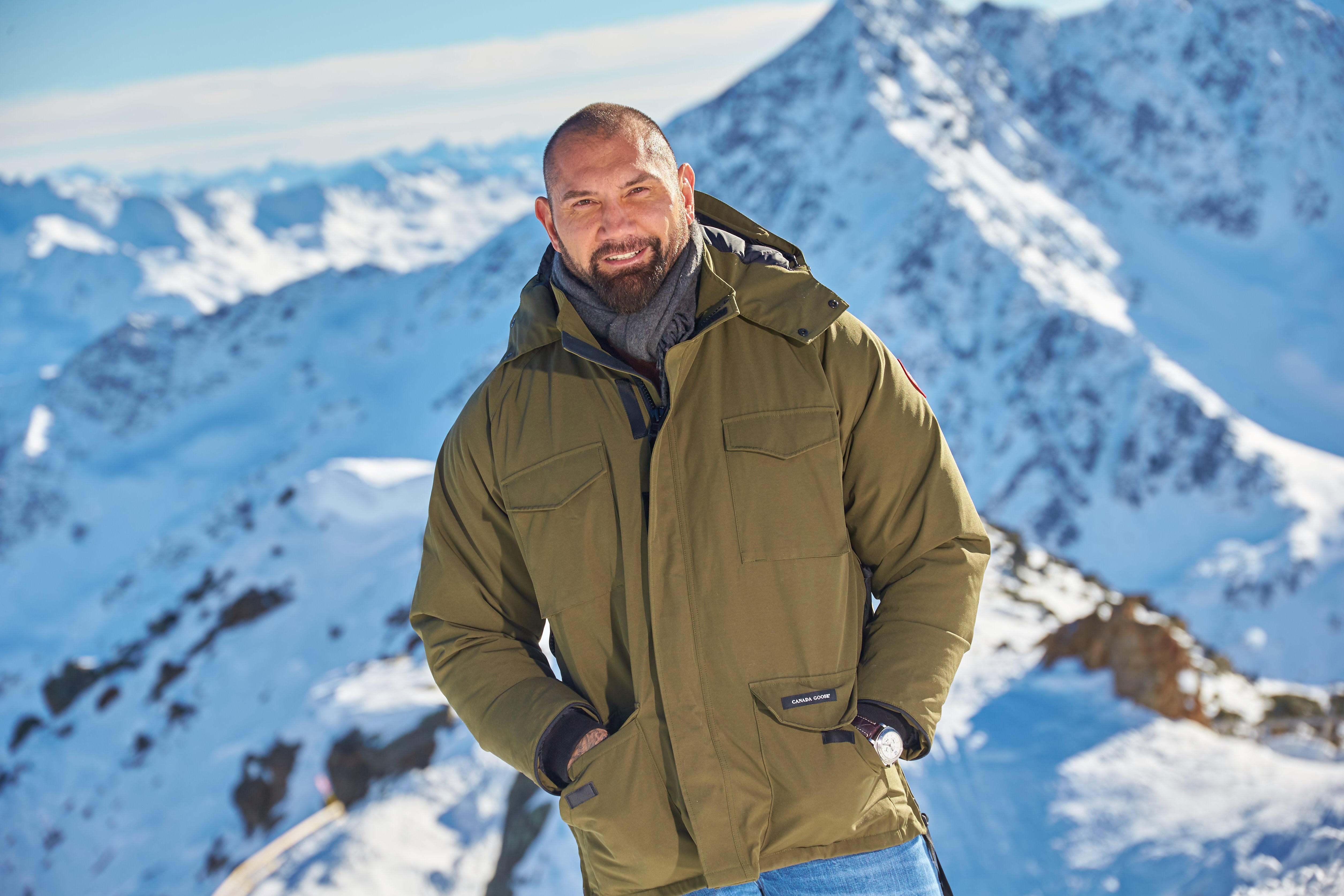 Dave Bautista in Canada Goose Jacket on Snowy Mountains HD Wallpaper