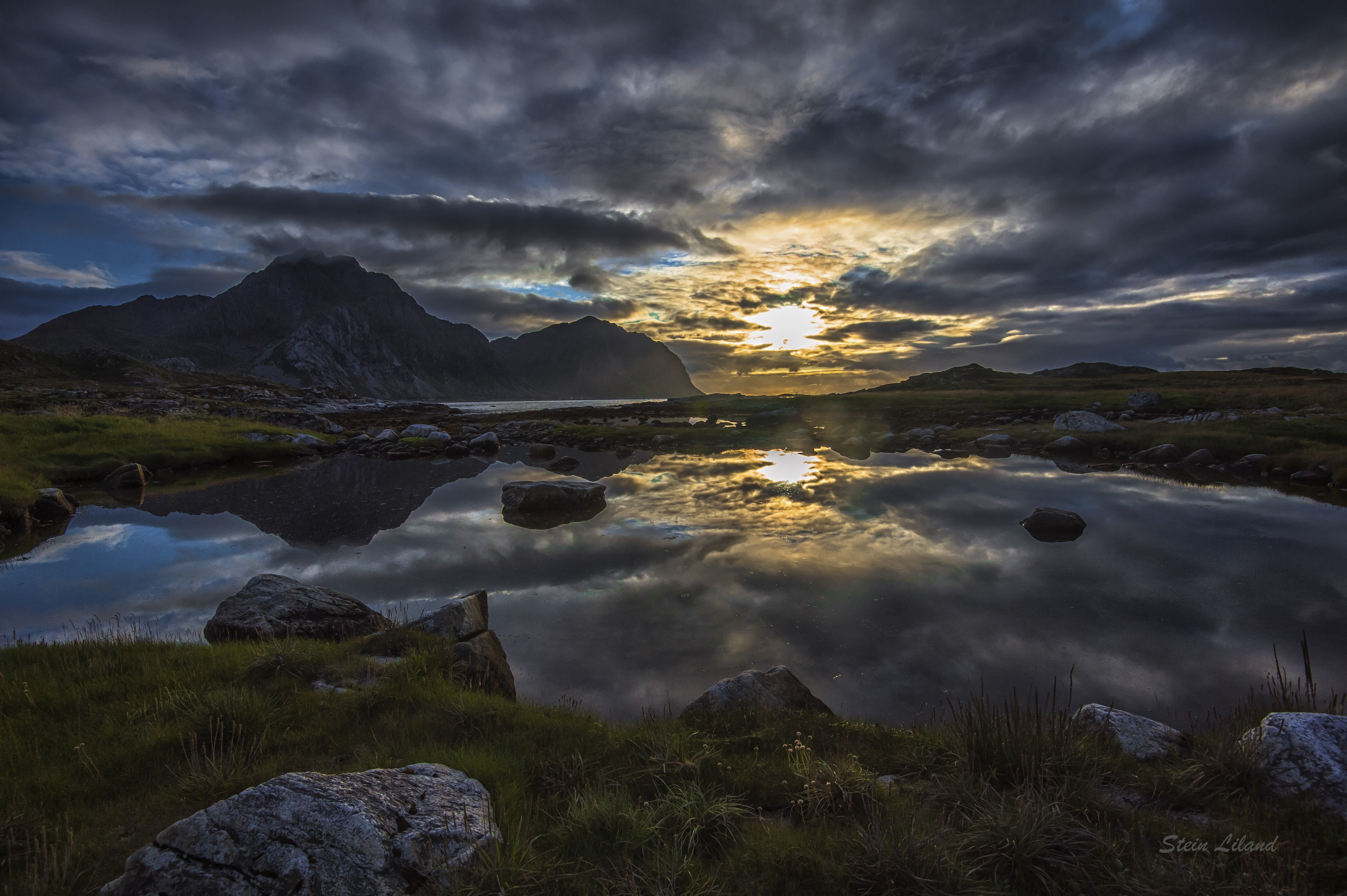 Sunset over mountains reflected in a lake HD Wallpaper