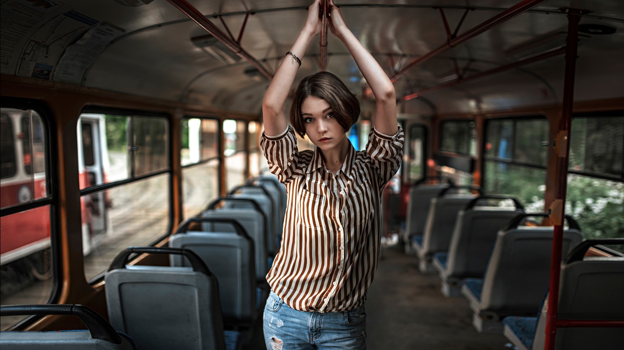 Woman in striped shirt inside a bus HD Wallpaper