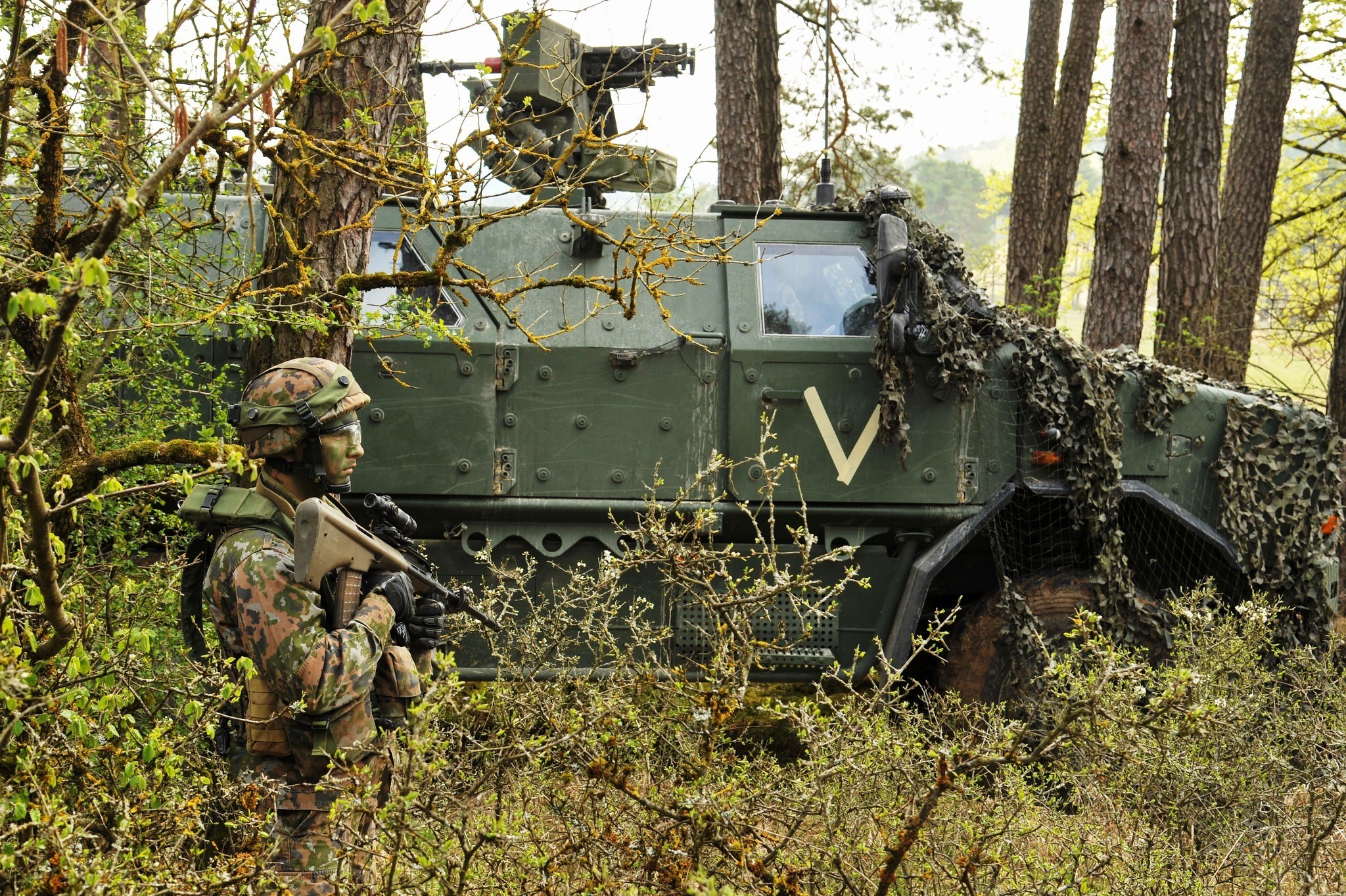 Soldier with military vehicle in forest HD Wallpaper