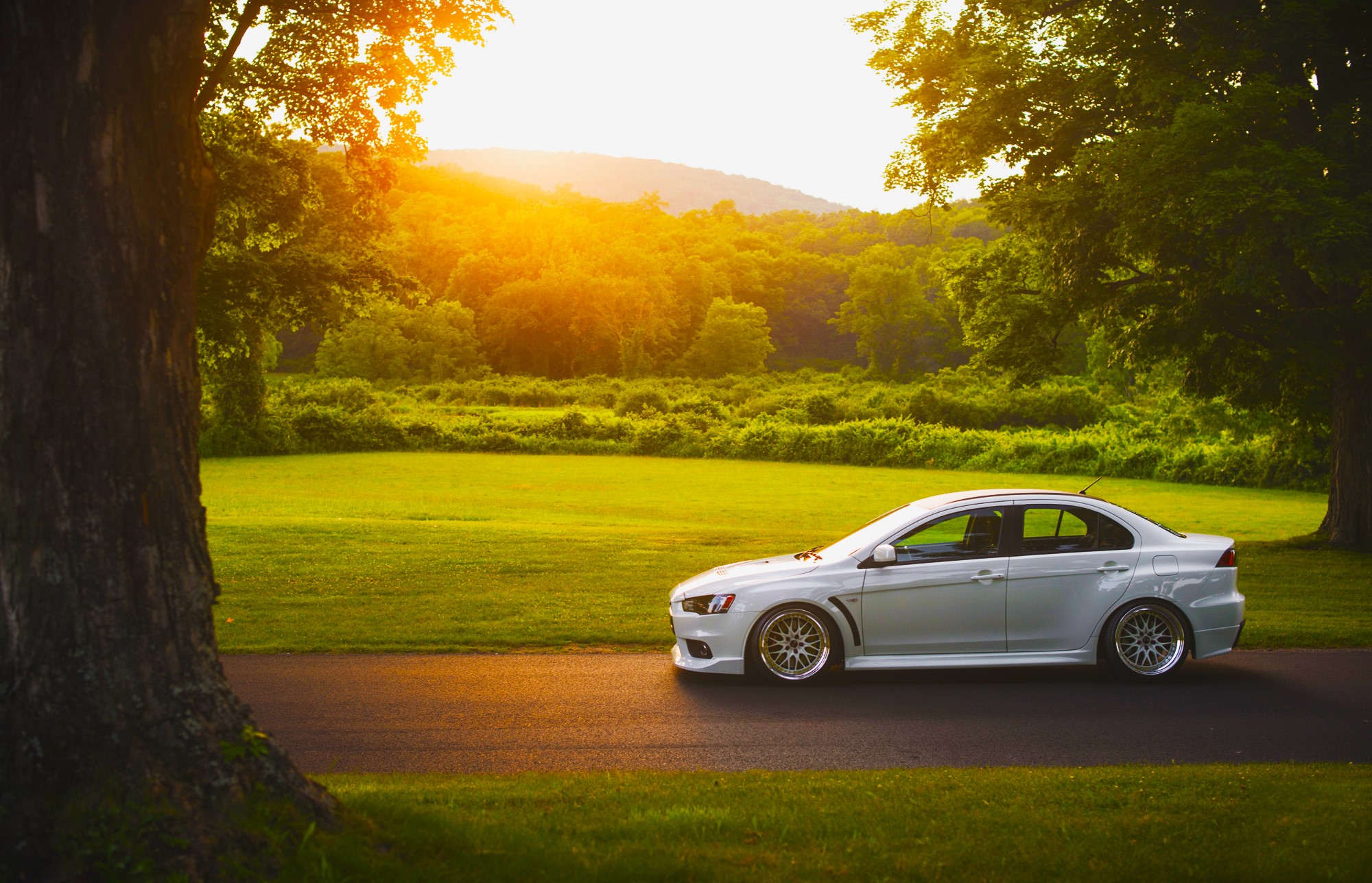 White Mitsubishi Lancer Evolution X on a road HD Wallpaper