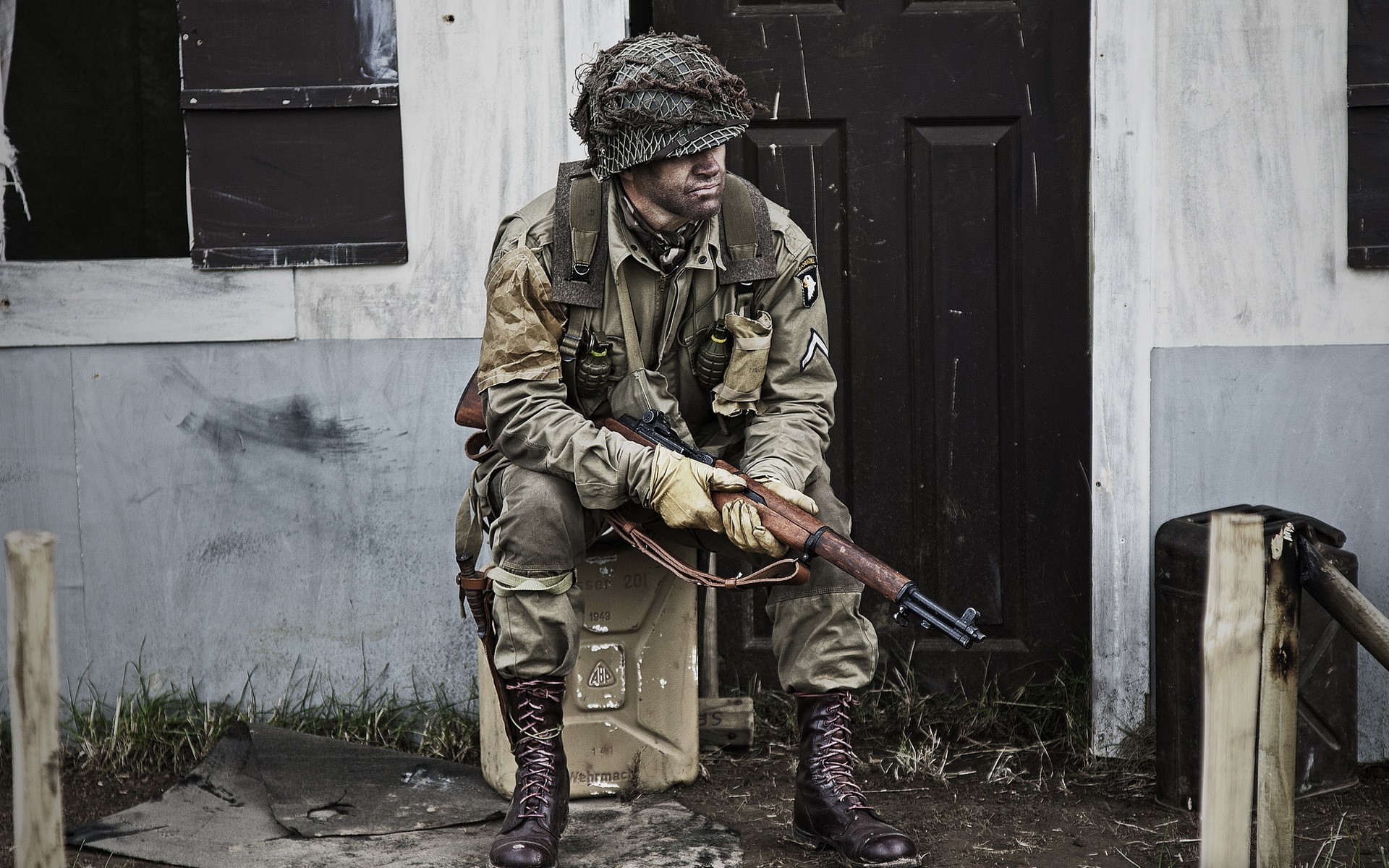 Soldier in uniform sitting with rifle HD Wallpaper