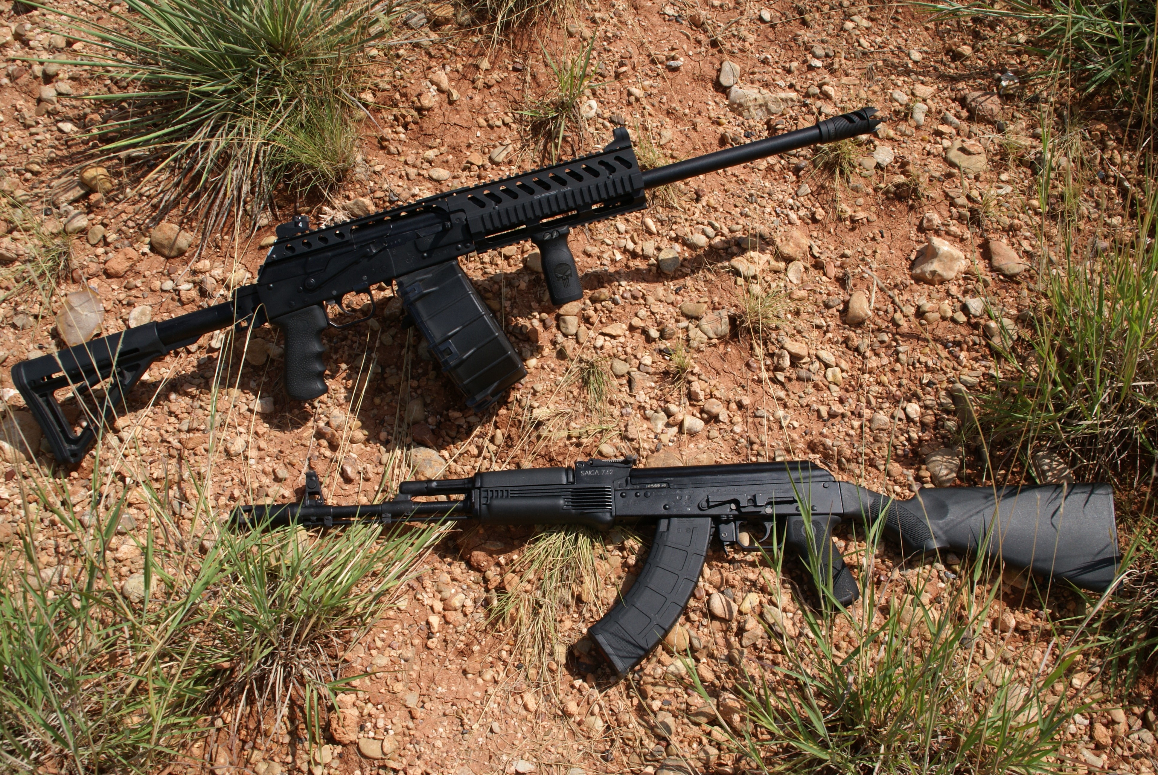 Two black shotguns on the ground HD Wallpaper