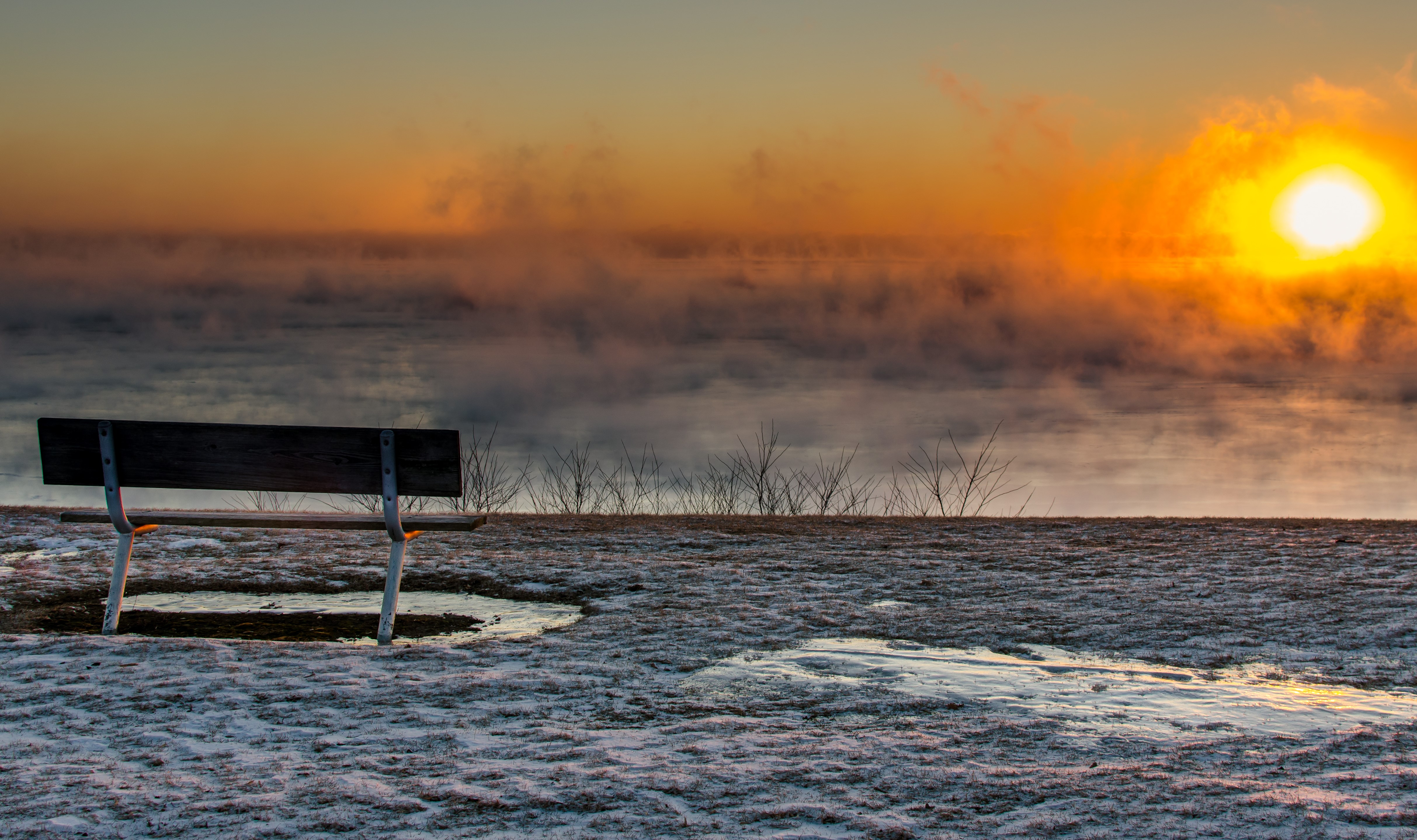 Bench overlooking foggy sunrise in winter HD Wallpaper