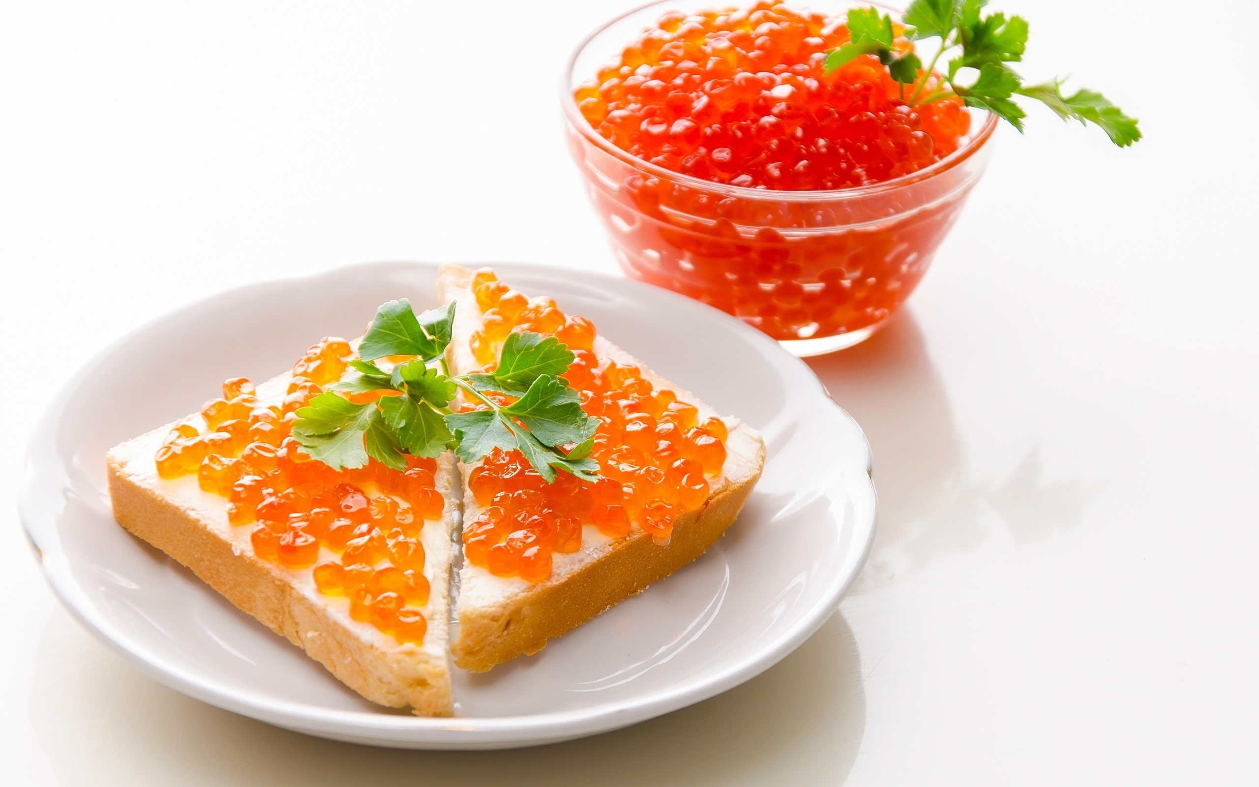 Toast with red caviar and parsley on a plate HD Wallpaper