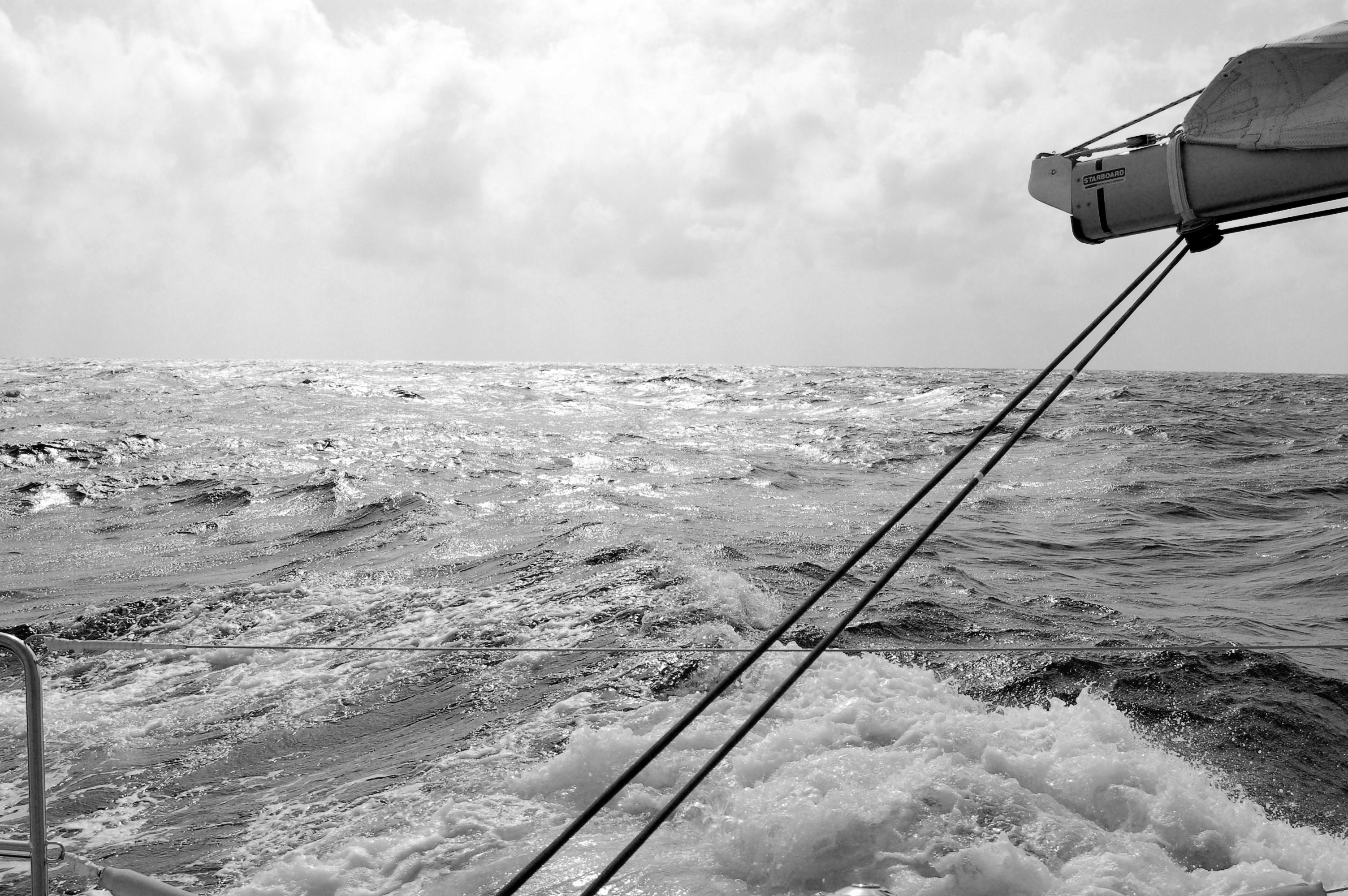 Sailing on a choppy sea under a cloudy sky HD Wallpaper