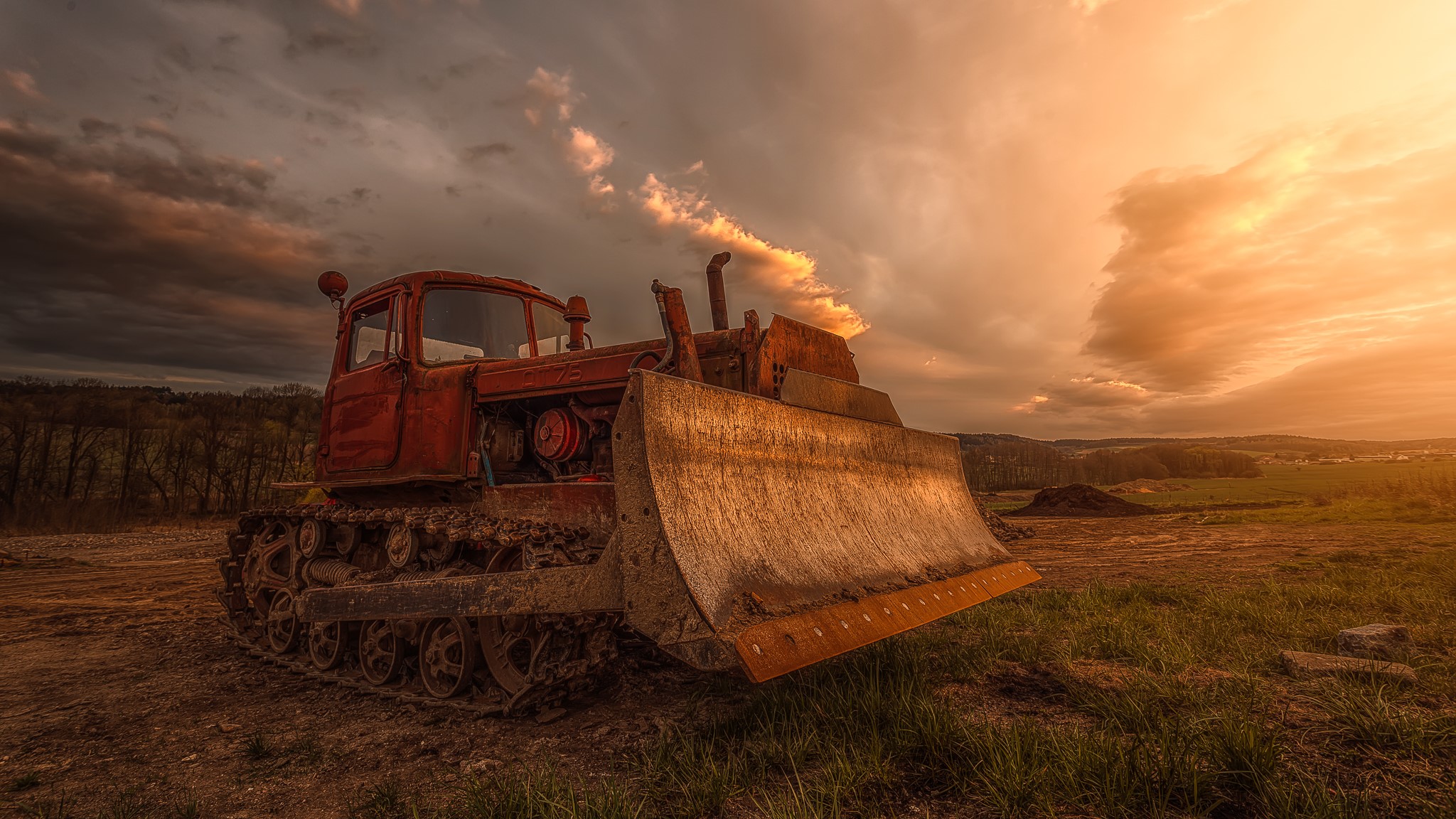 Red bulldozer in a field at sunset HD Wallpaper