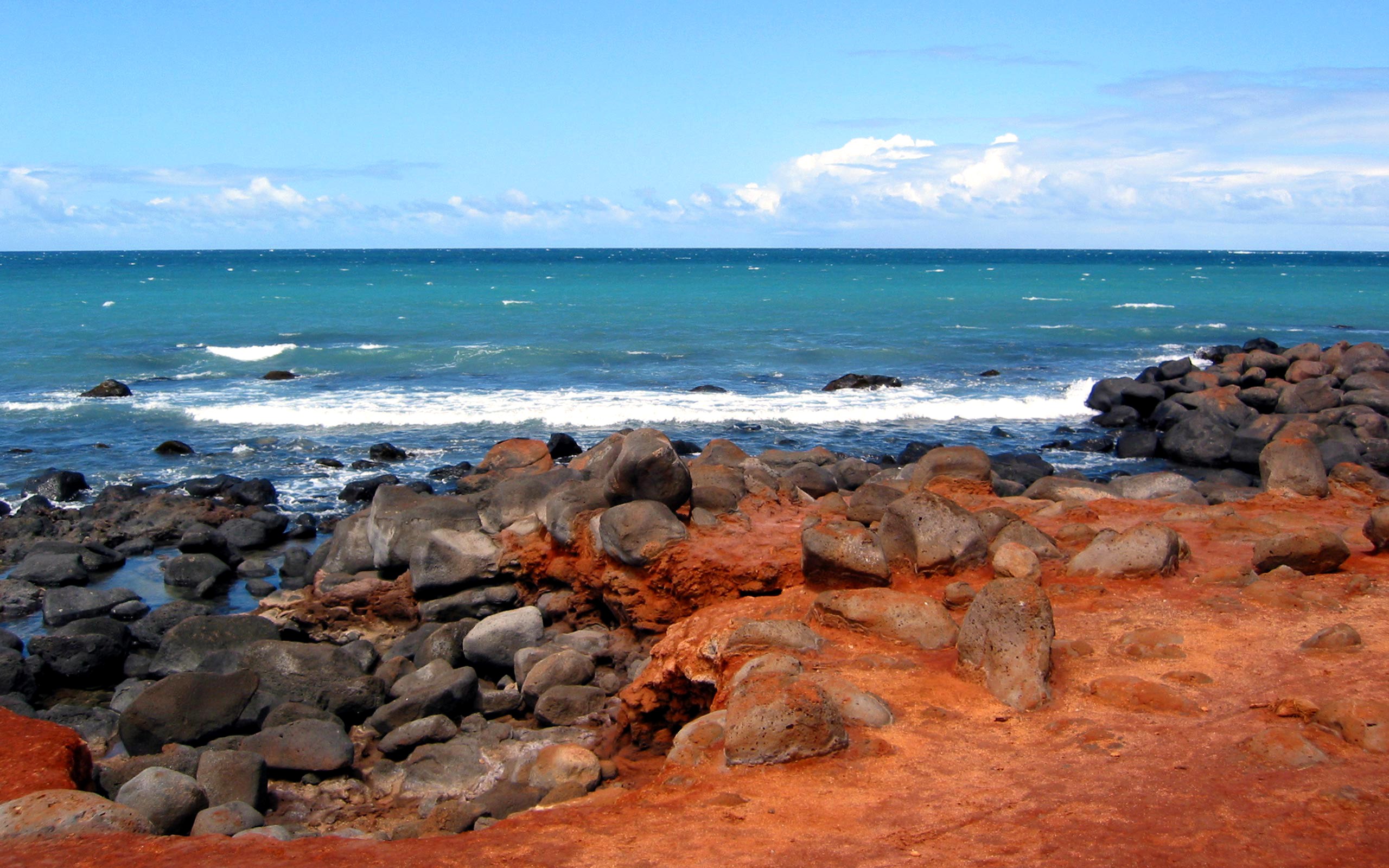 Rocky Coastline with Turquoise Ocean and Blue Sky HD Wallpaper