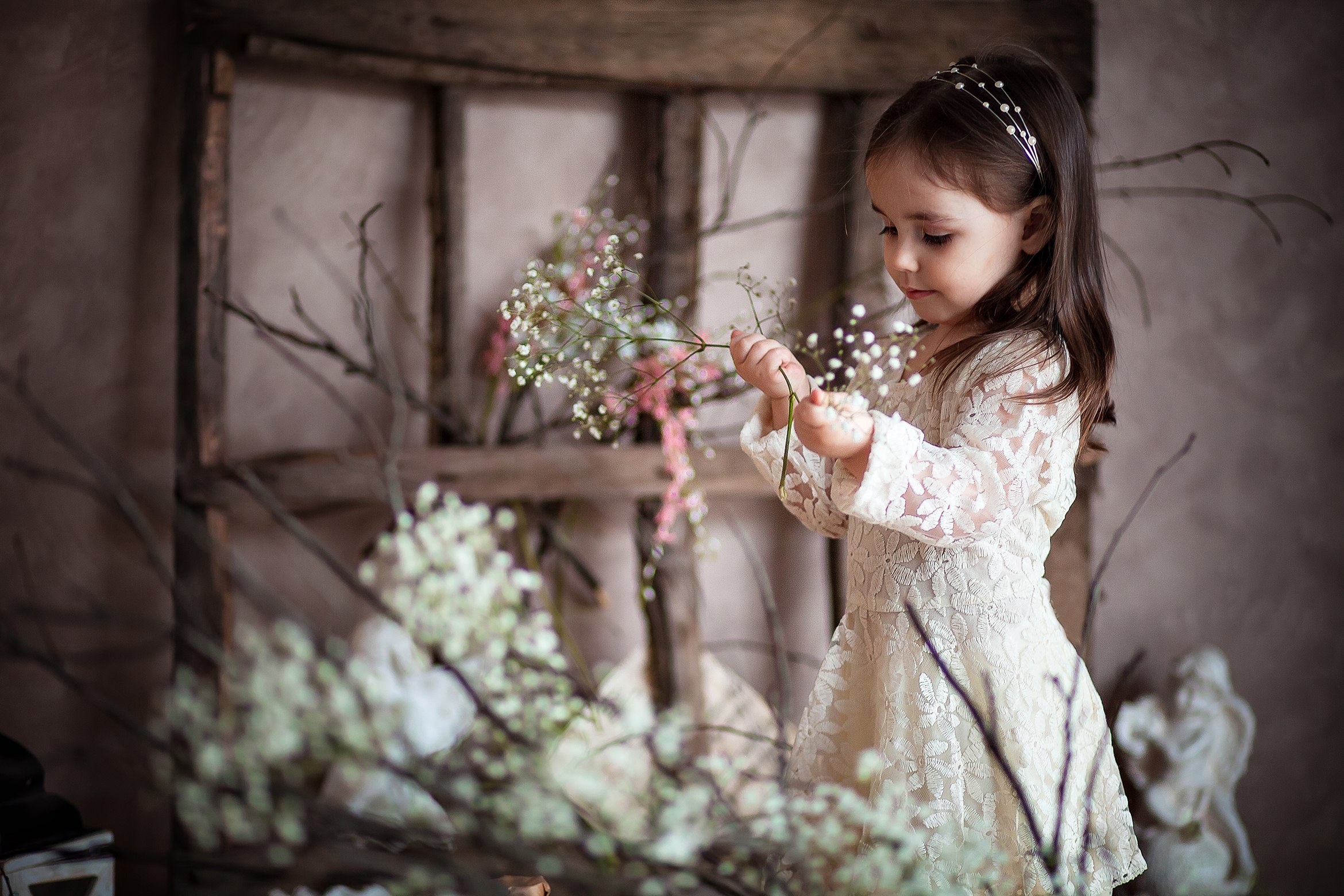 Young girl in a lace dress holding flowers HD Wallpaper
