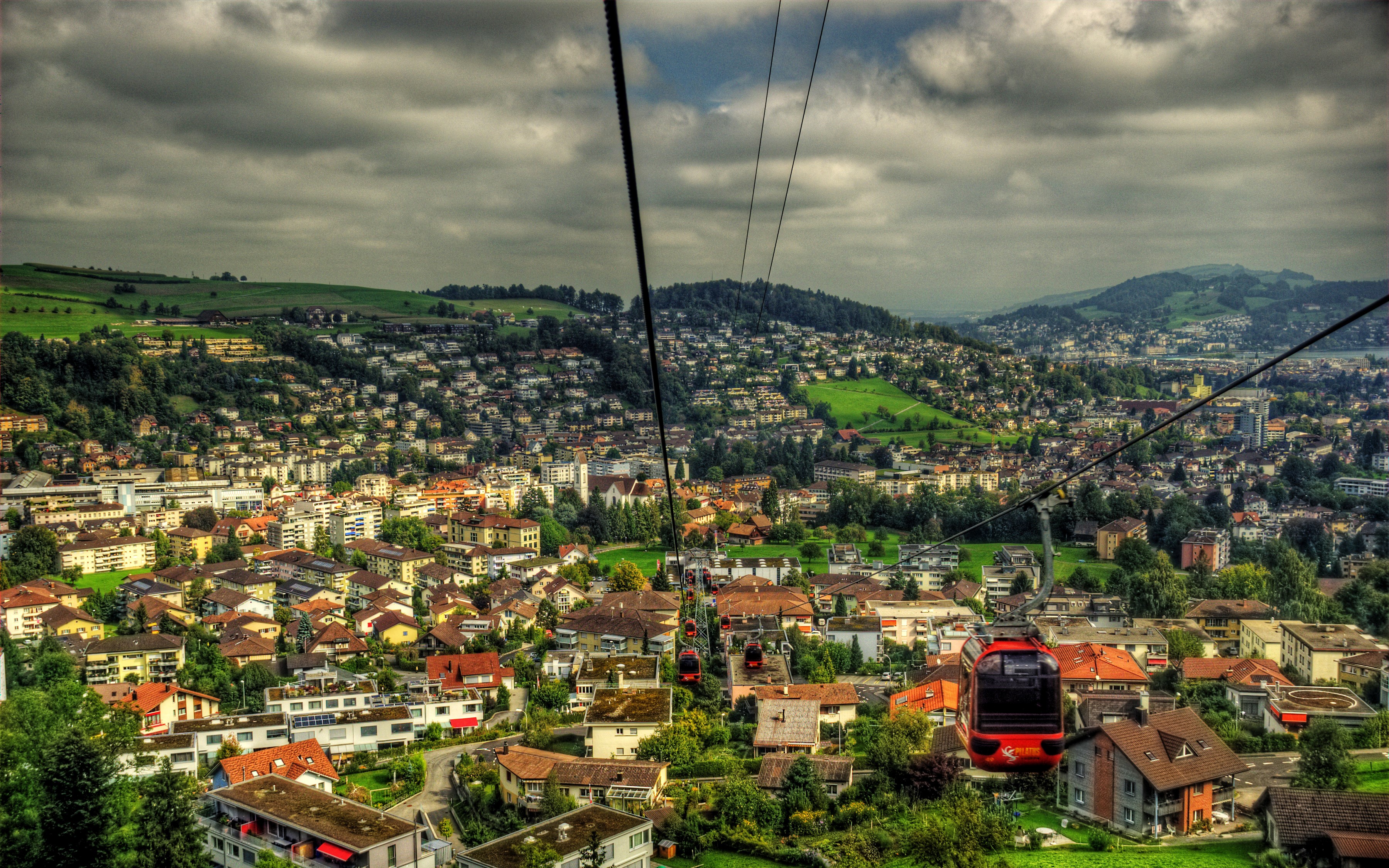 Cable car over Luzern, Switzerland with houses and hills HD Wallpaper