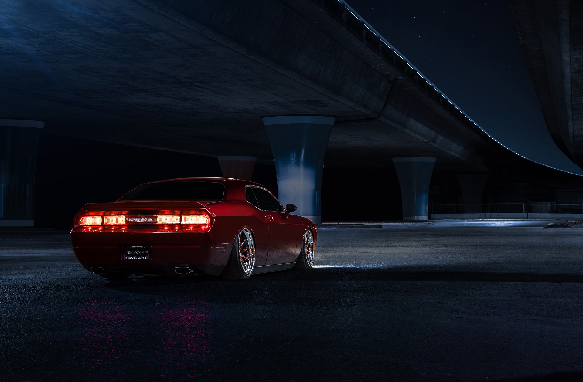 Red Dodge Challenger under a bridge at night HD Wallpaper