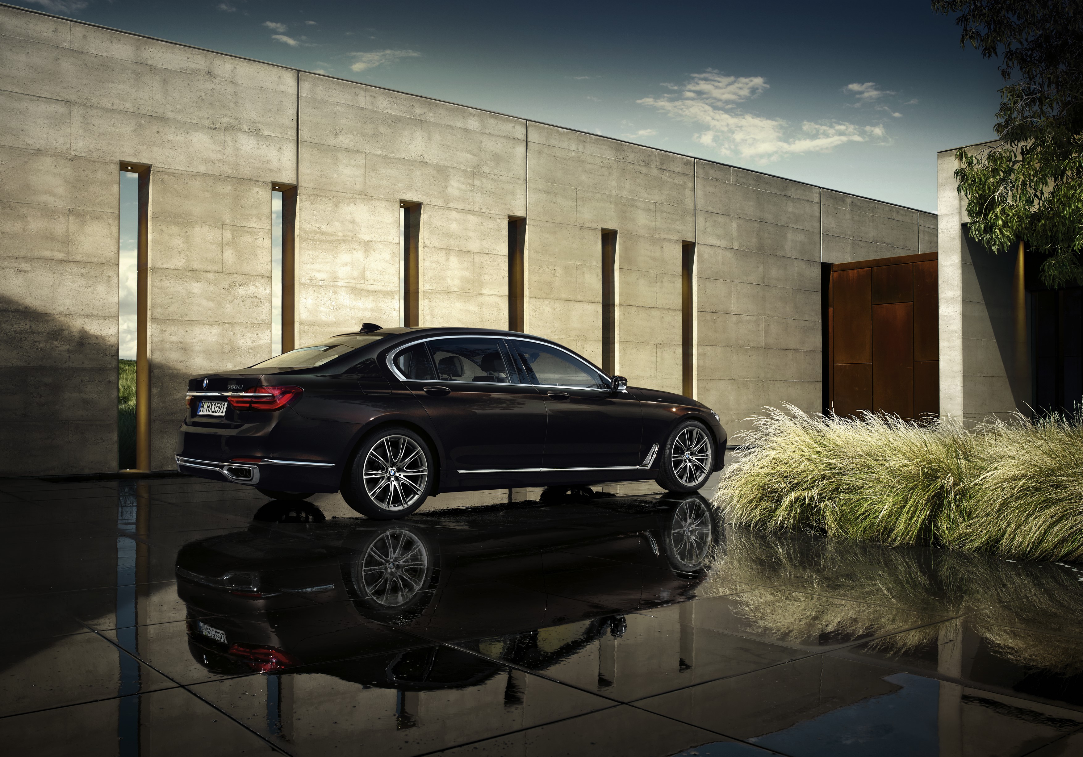 Black BMW 750Li xDrive Individual parked by modern building HD Wallpaper