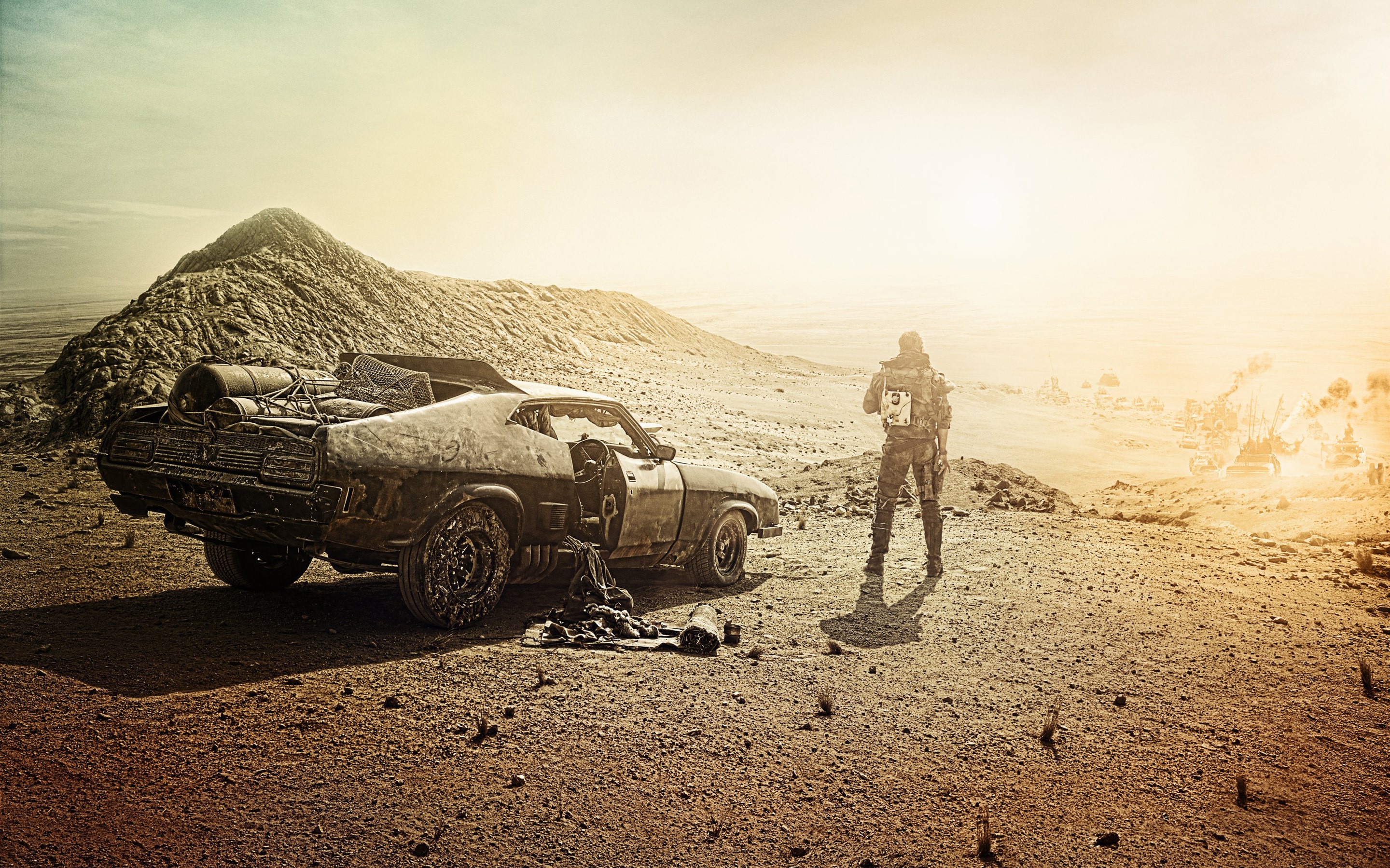Mad Max: Fury Road desert scene with car and man HD Wallpaper