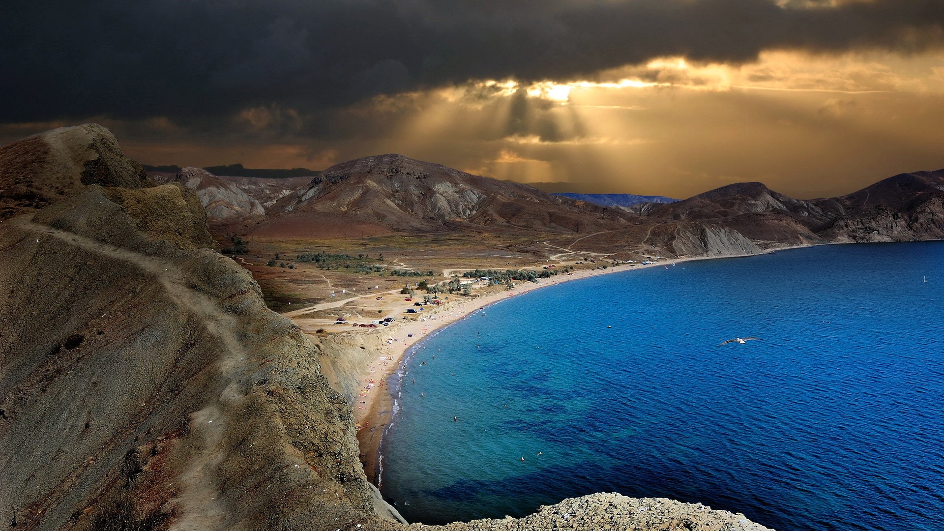 Sea and mountains under stormy sky HD Wallpaper