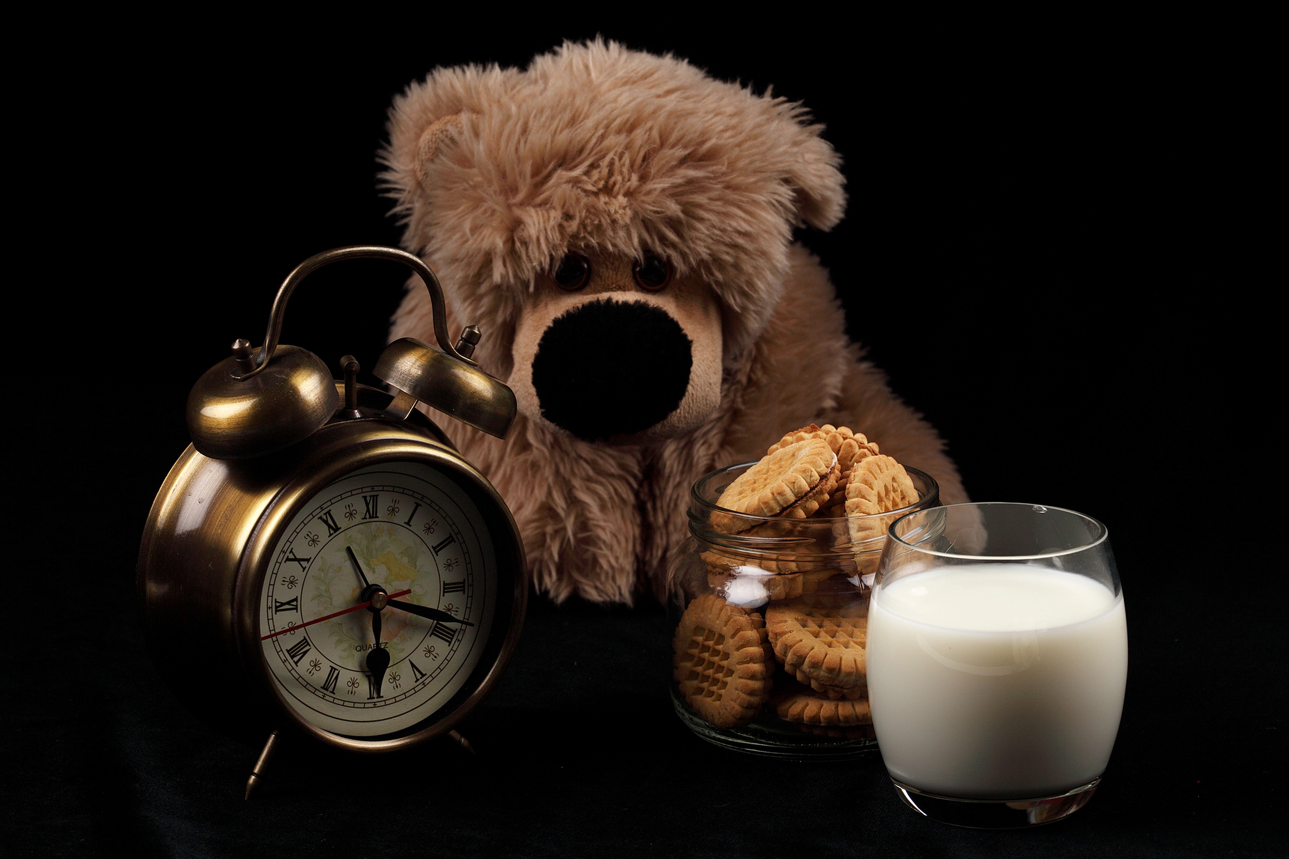 Teddy bear with alarm clock, cookies, and milk HD Wallpaper