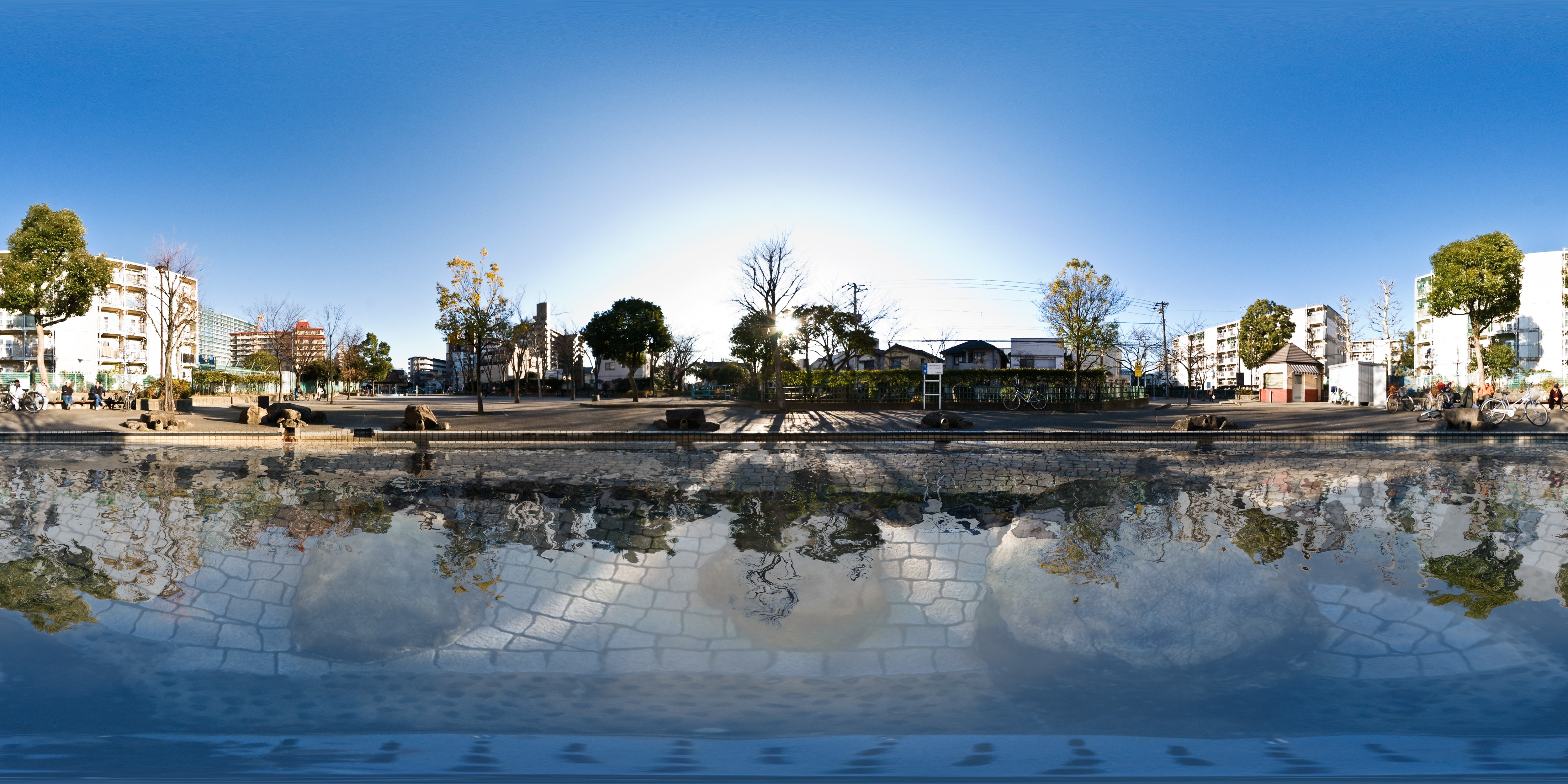 Park with buildings and water reflection in Tokyo HD Wallpaper