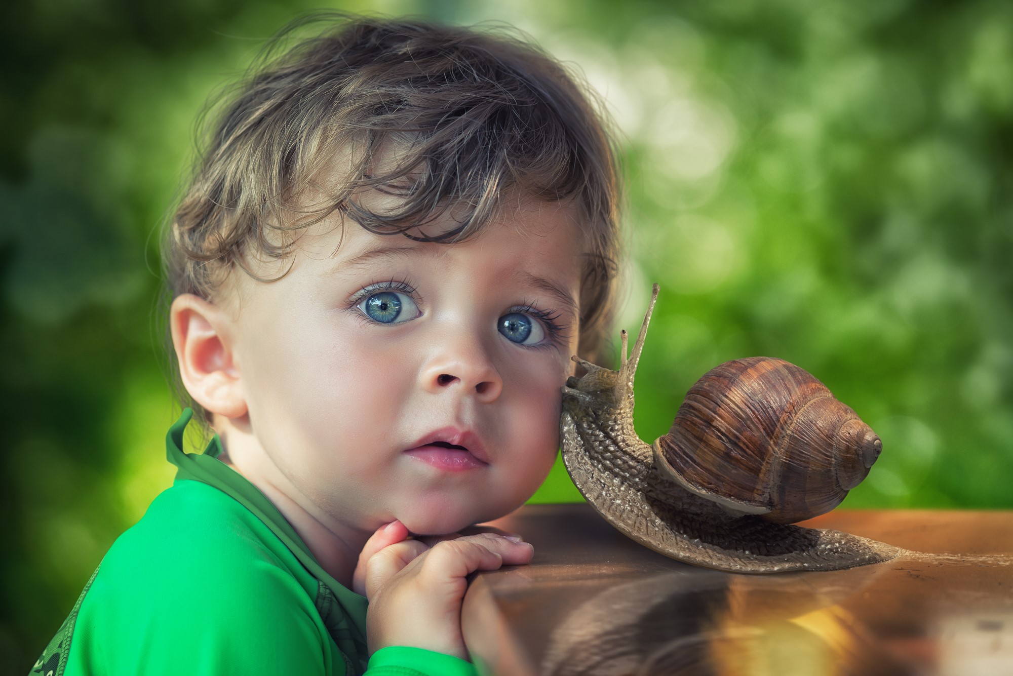 Boy and Snail on a Wooden Surface HD Wallpaper