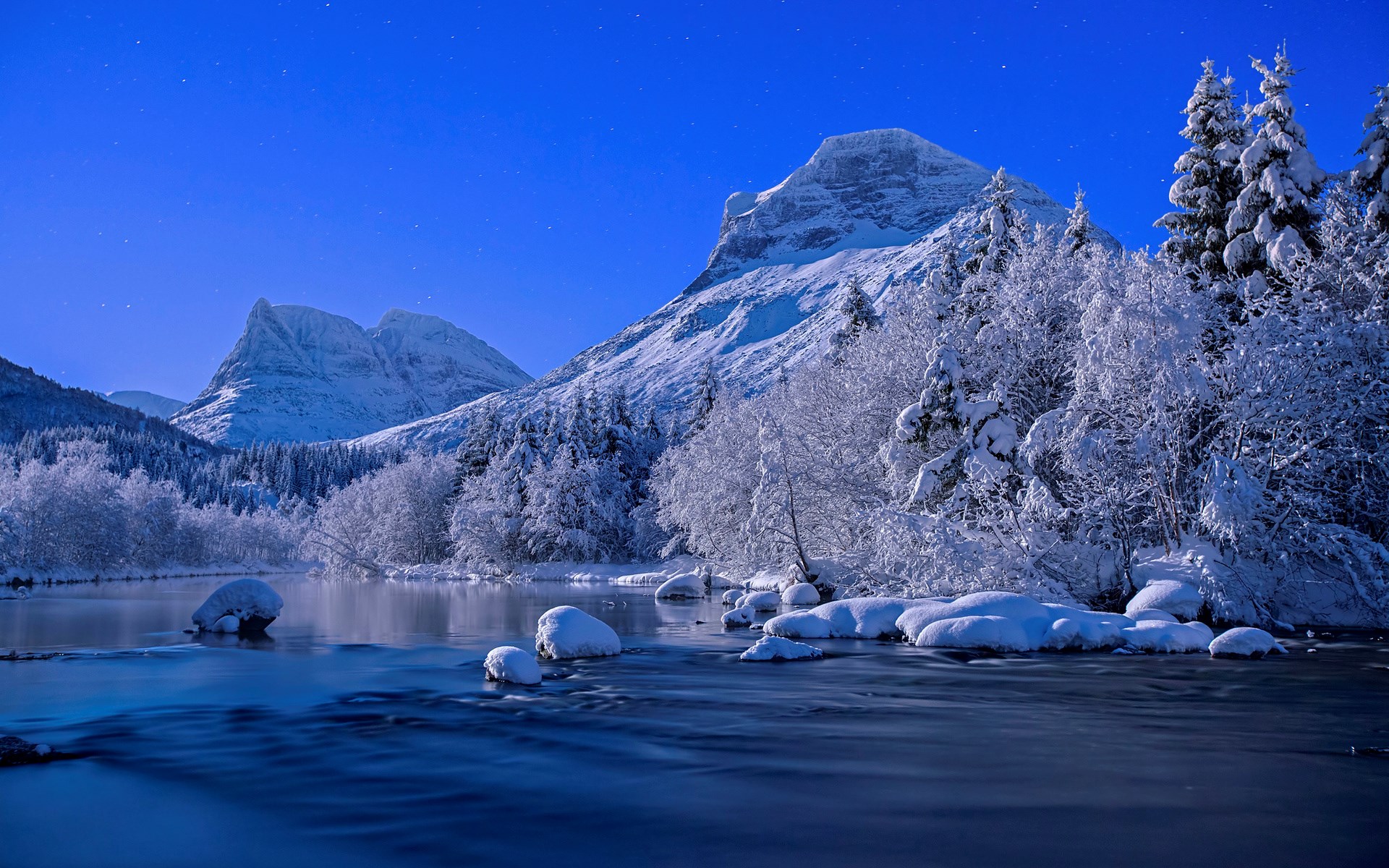 Snowy Mountains and River Under a Starry Blue Sky HD Wallpaper