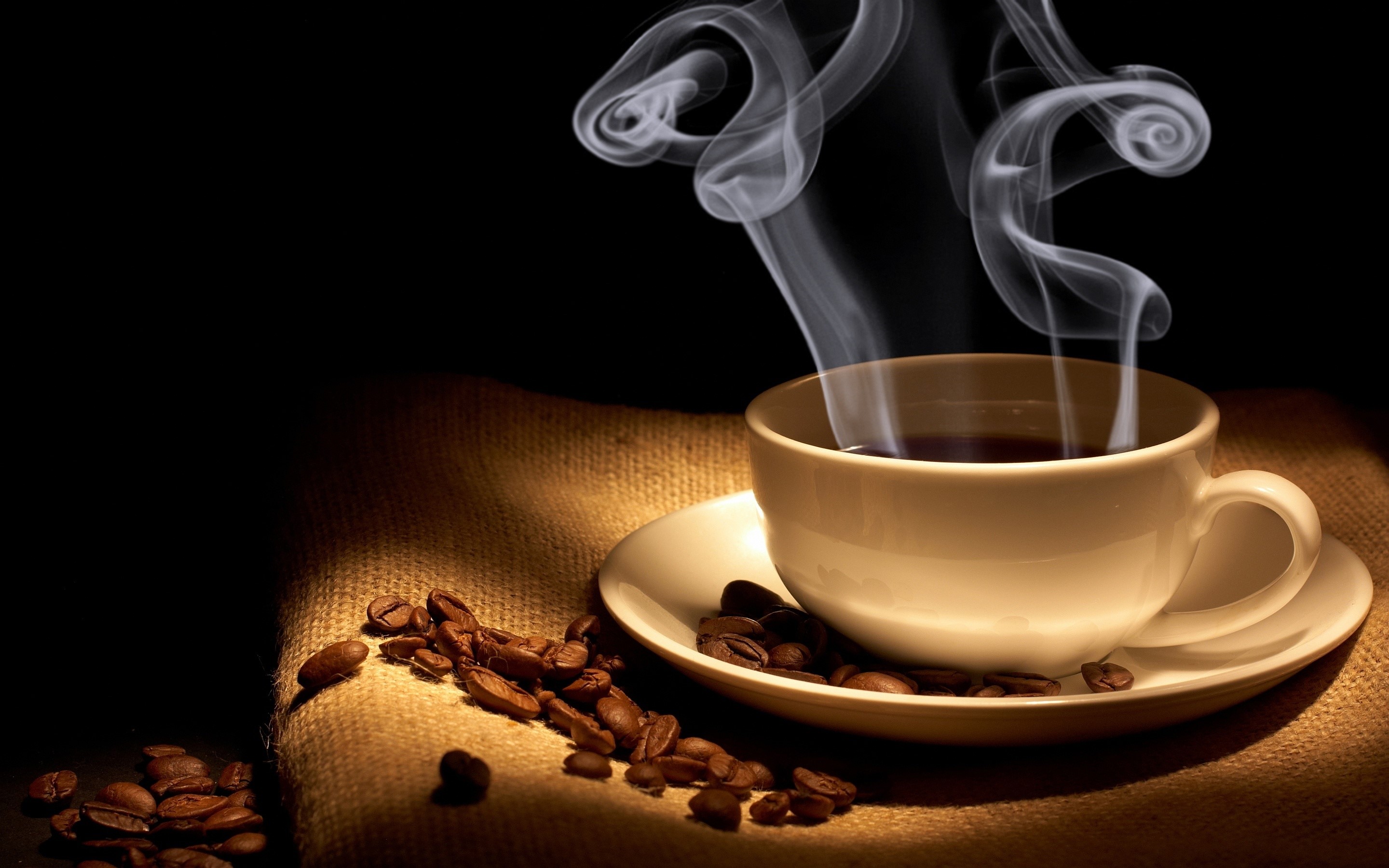 Steaming cup of coffee with coffee beans HD Wallpaper