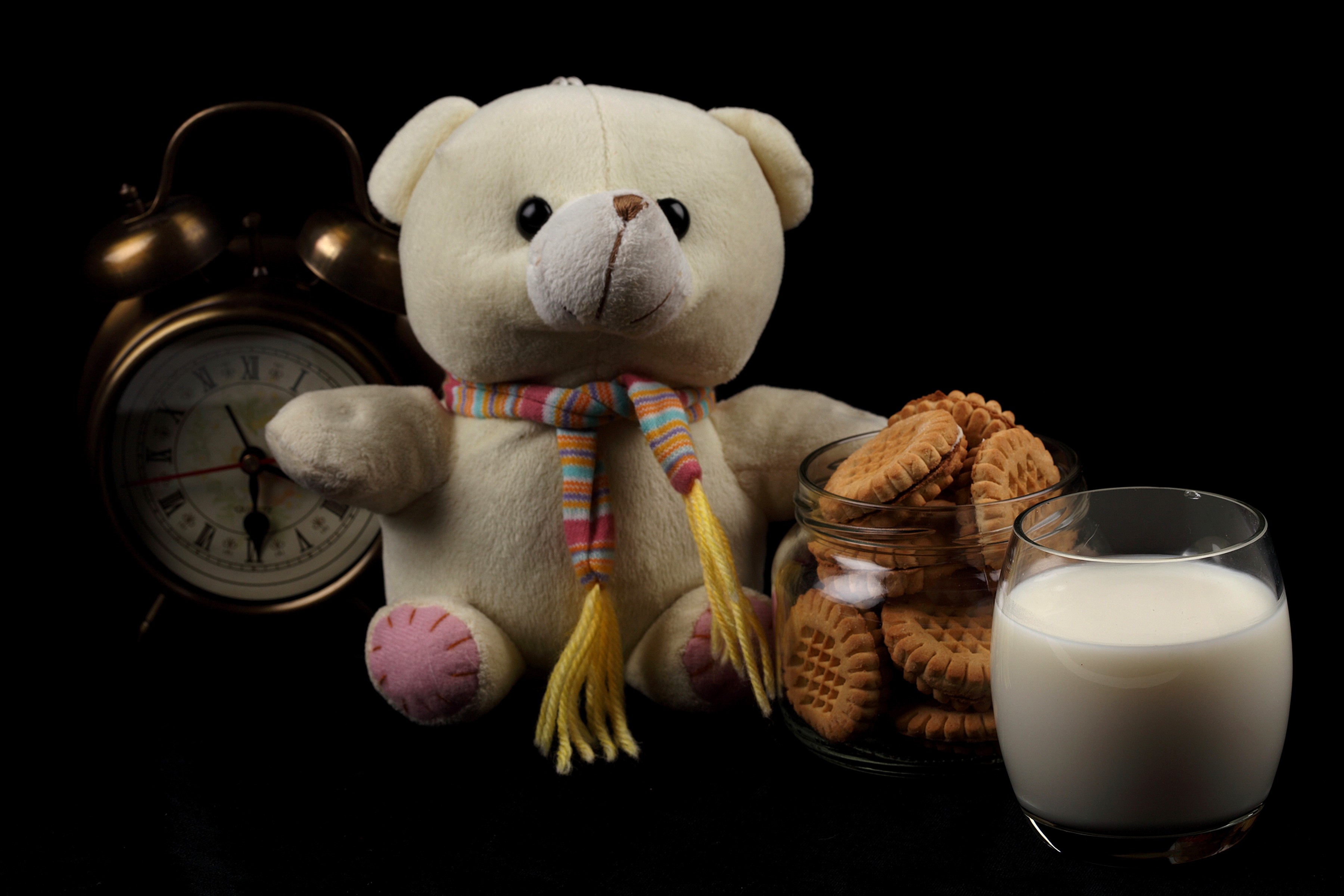 Teddy bear with cookies and milk next to an alarm clock HD Wallpaper