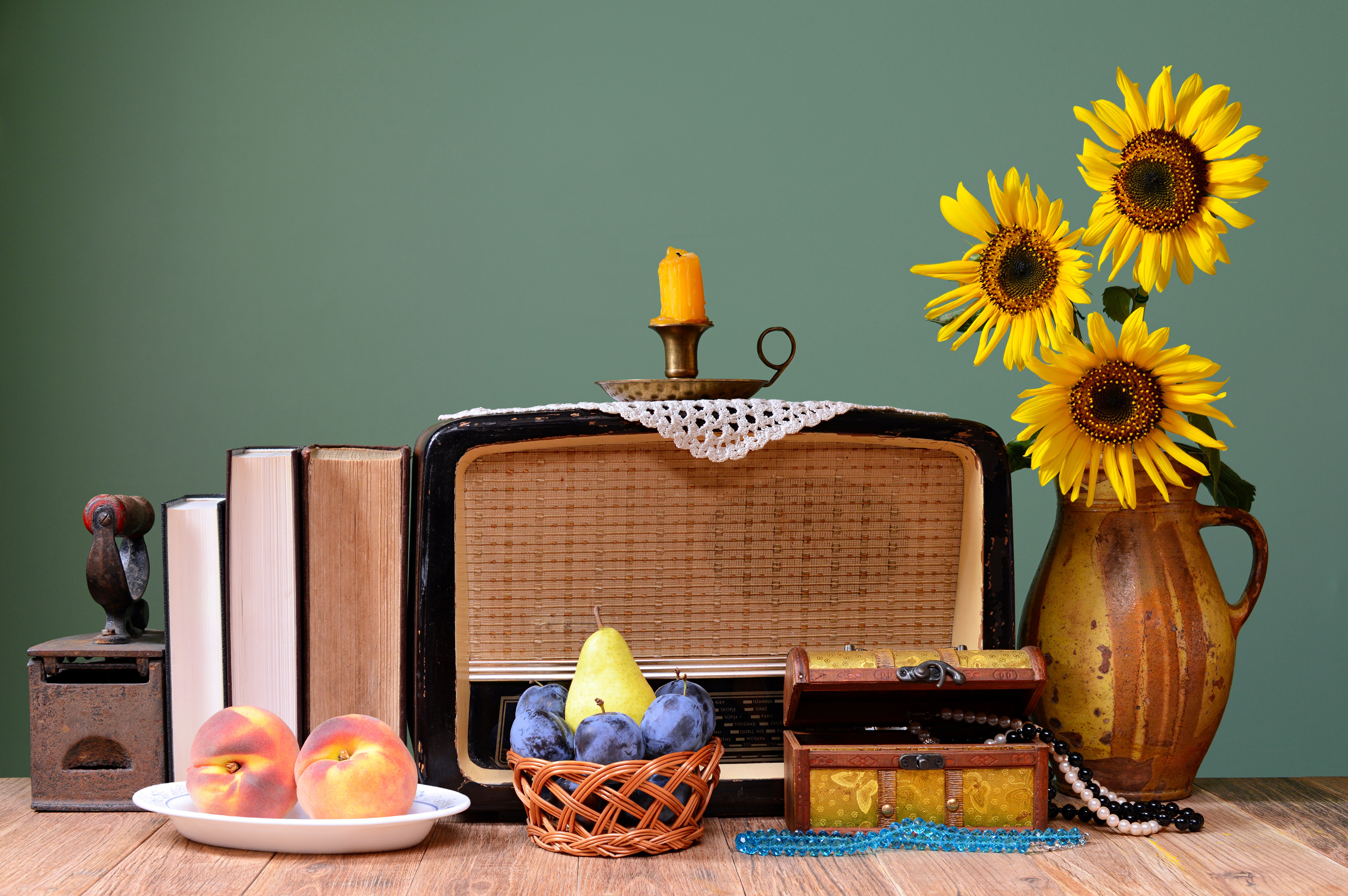 Still life with vintage radio, fruit, books, and sunflowers HD Wallpaper