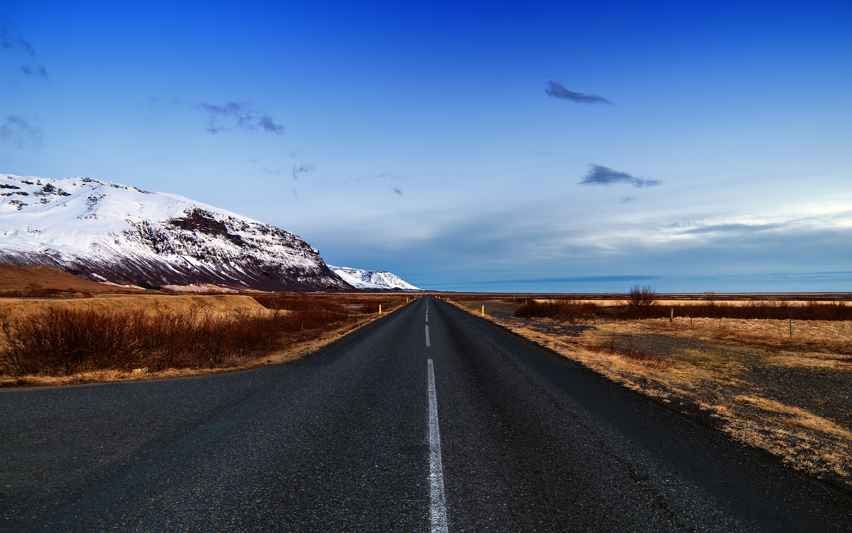 Road through Iceland with snow-capped mountains HD Wallpaper