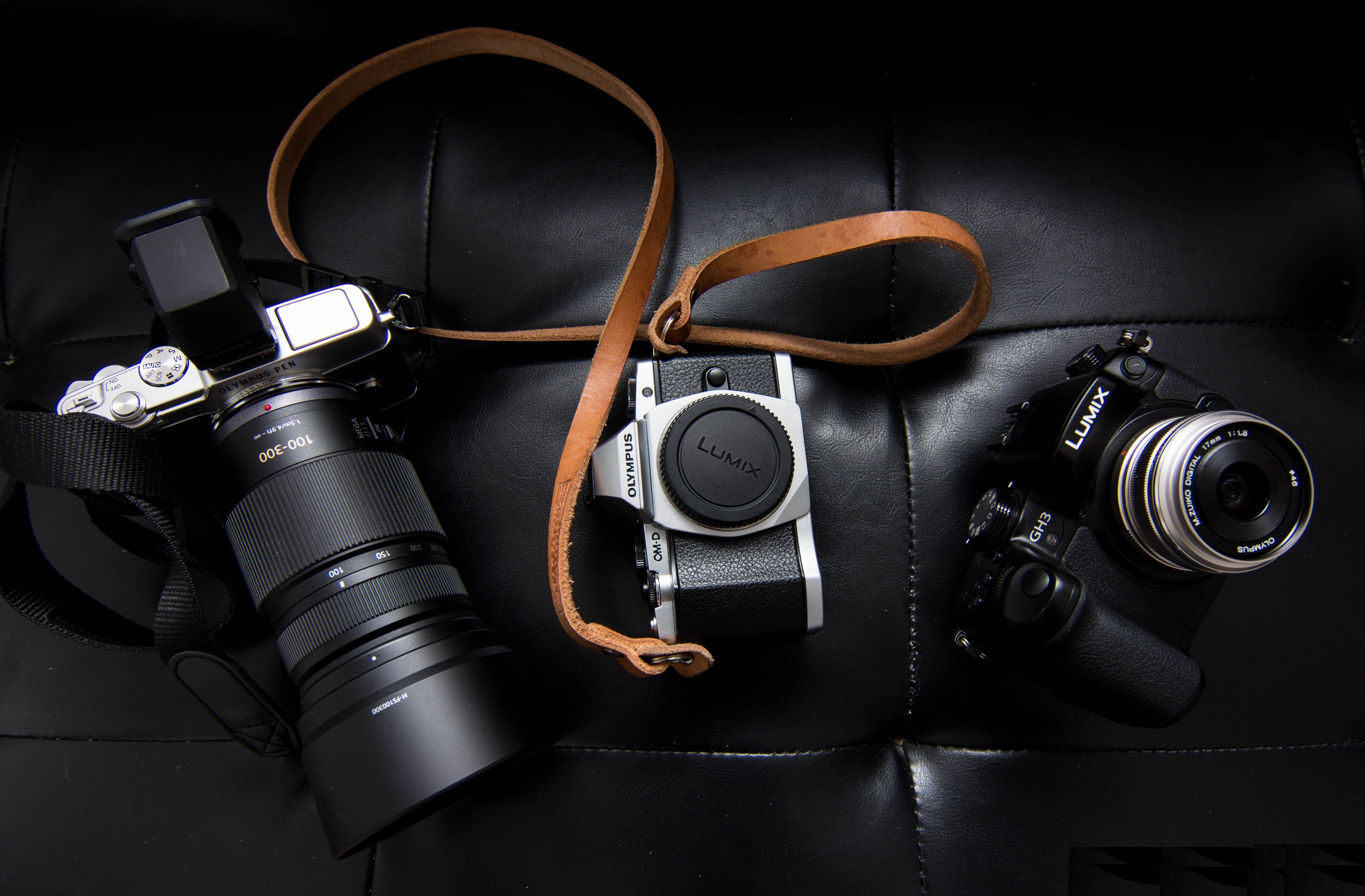 Lumix Olympus Cameras with Leather Strap HD Wallpaper